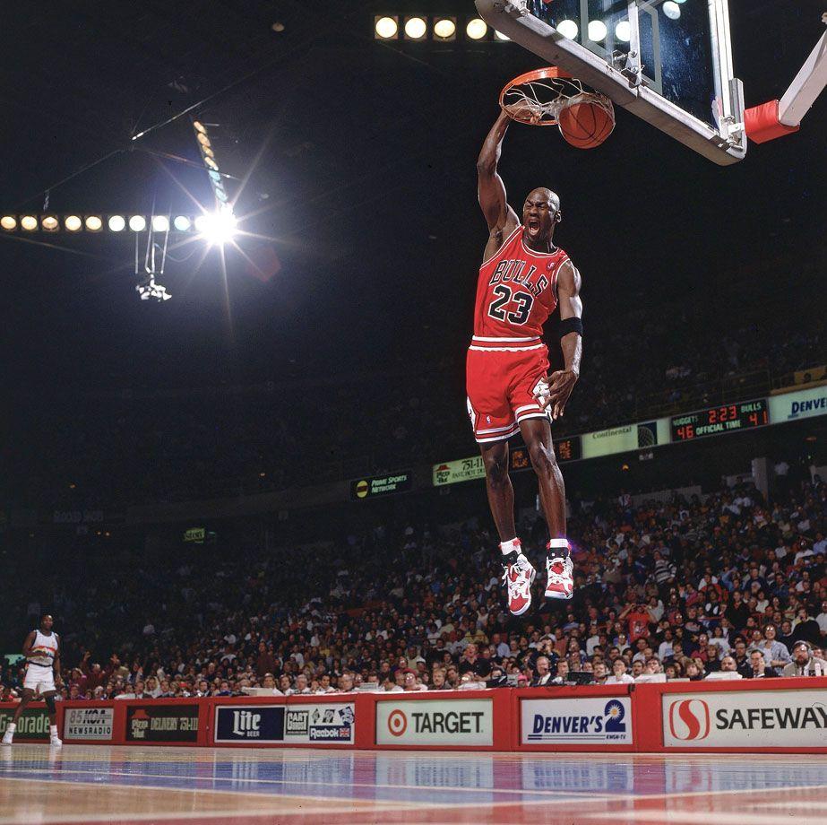 Download Michael Jordan flies through the air making a legendary dunk  Wallpaper