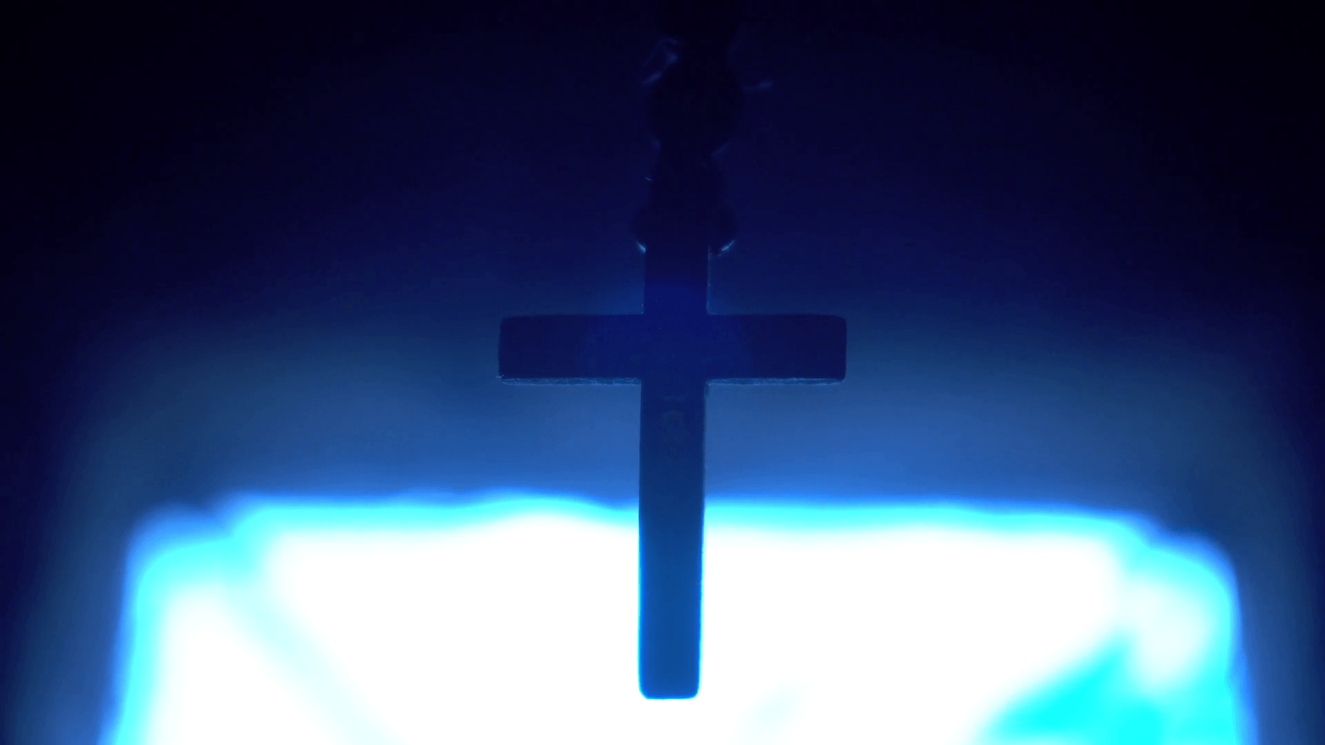 Rosary Cross on a background of blue light Stock Video Footage