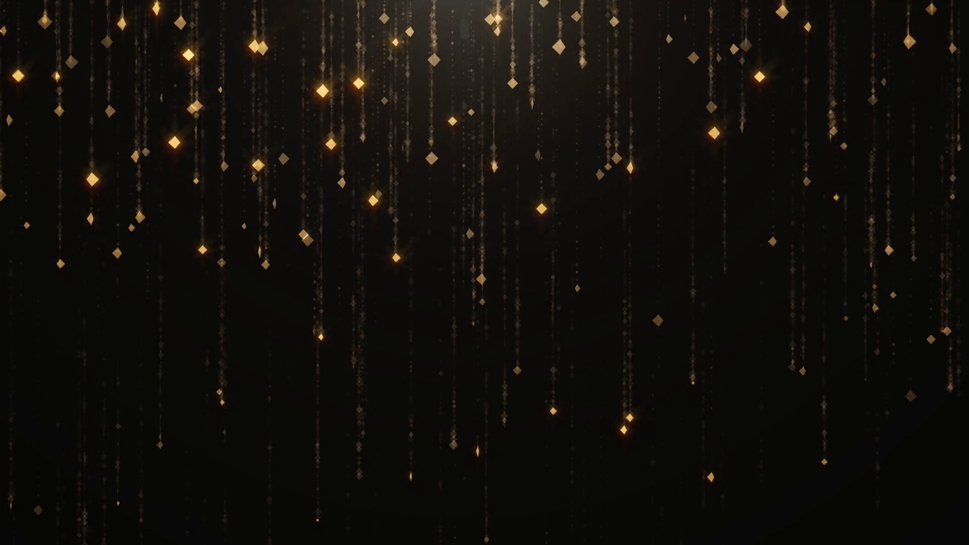 Falling gold particles flicker and shimmer against a black