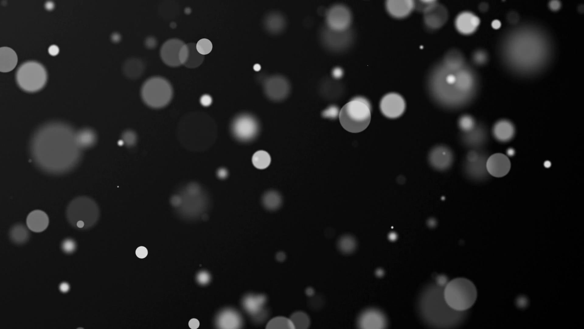 Abstract animation of moving blurred lights on black background