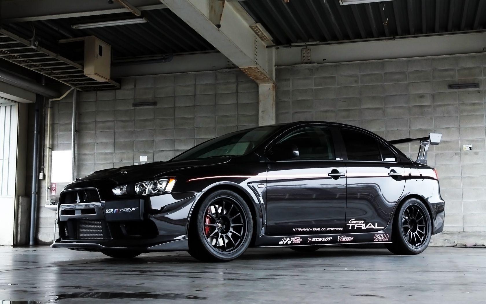 Black Mitsubishi Lancer Evo X in the garage wallpaper and image