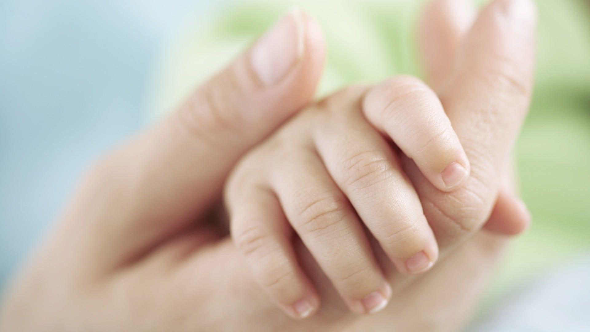 Mother holding baby hand HD wallpaper