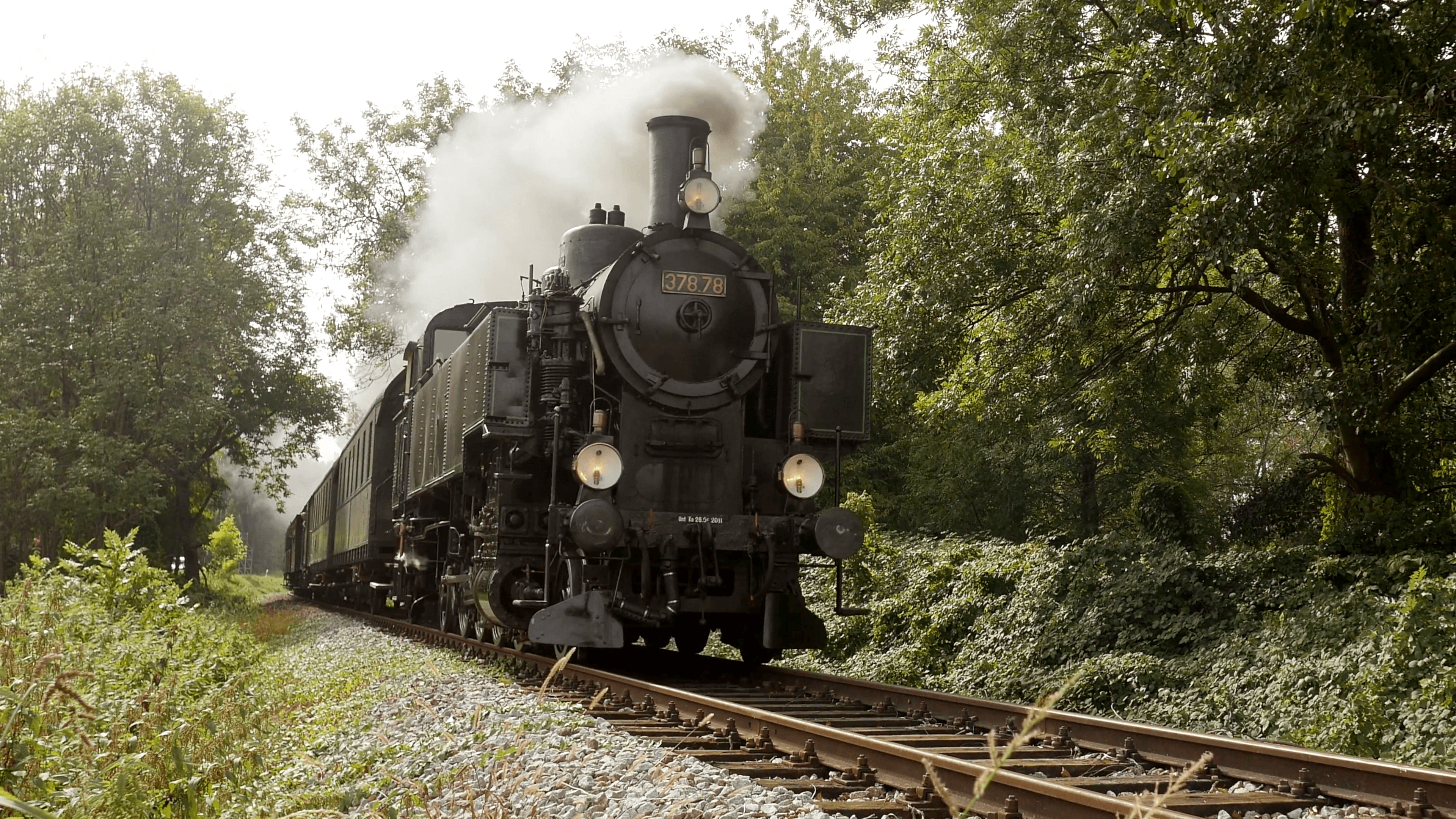 historical steam engine train driving on railroad. nostalgic