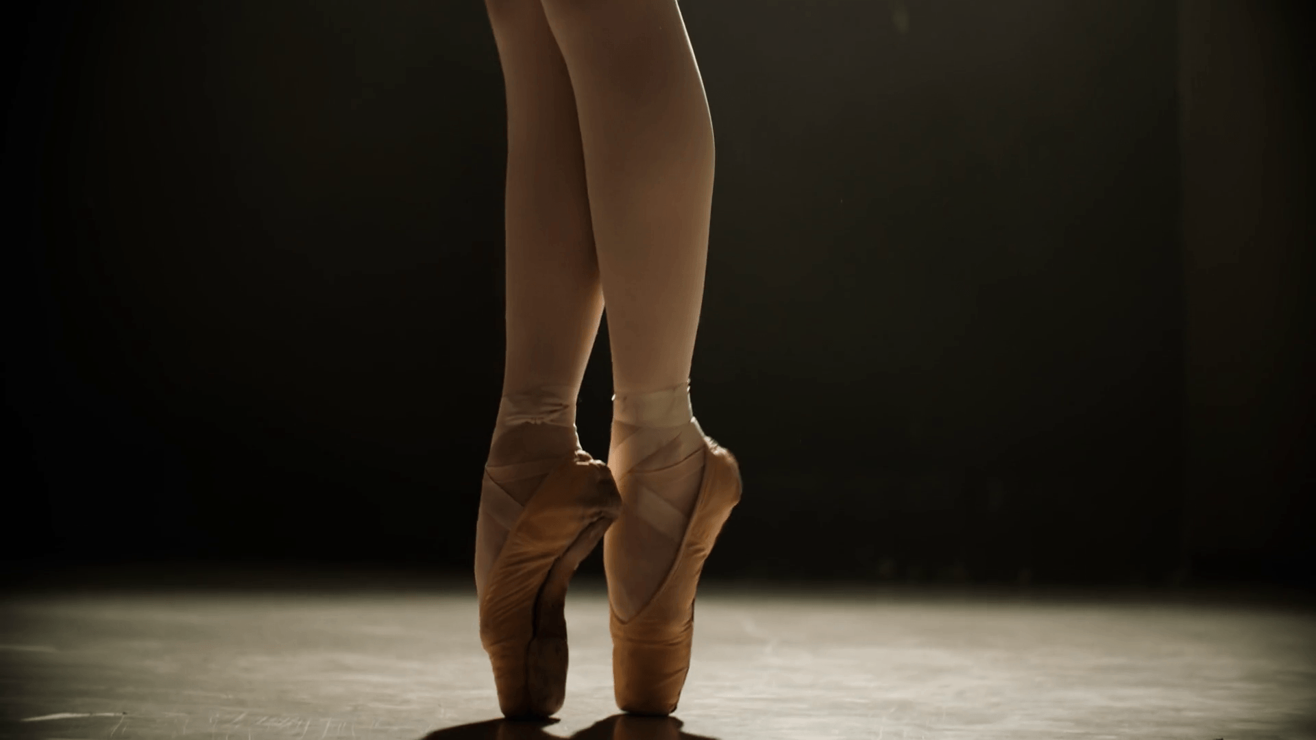Close Up Of Ballerina Feet In Pointe Shoes Dancing Ballet Elements, Slow Motion, Dark Background Stock Video Footage