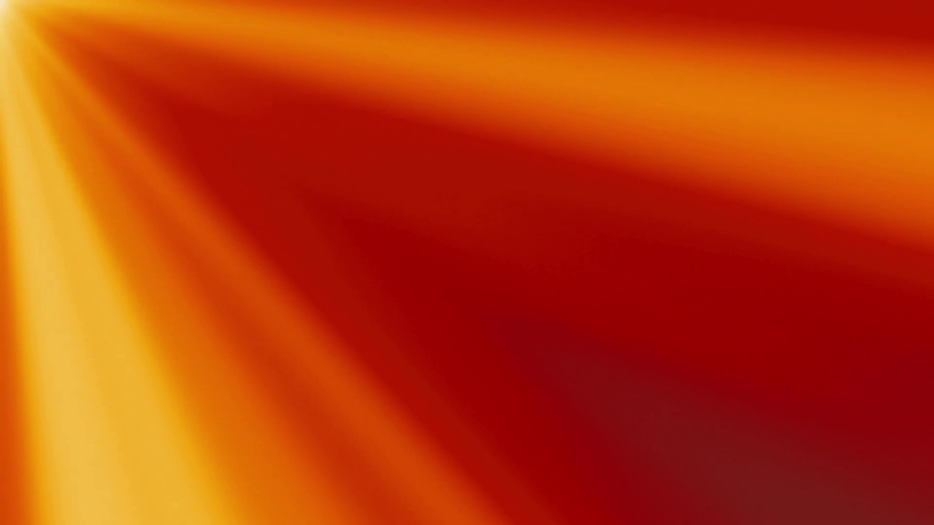 Looping clip of yellow and orange light rays on a red background
