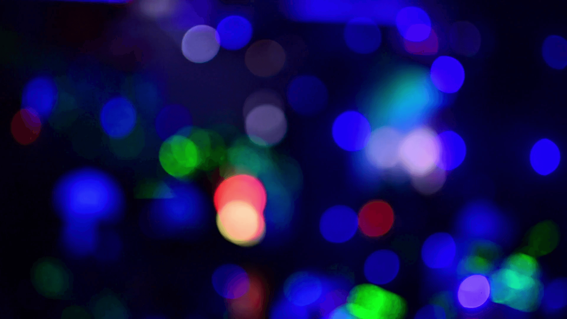 Background of multicolored blurred round light glare. Disco lights