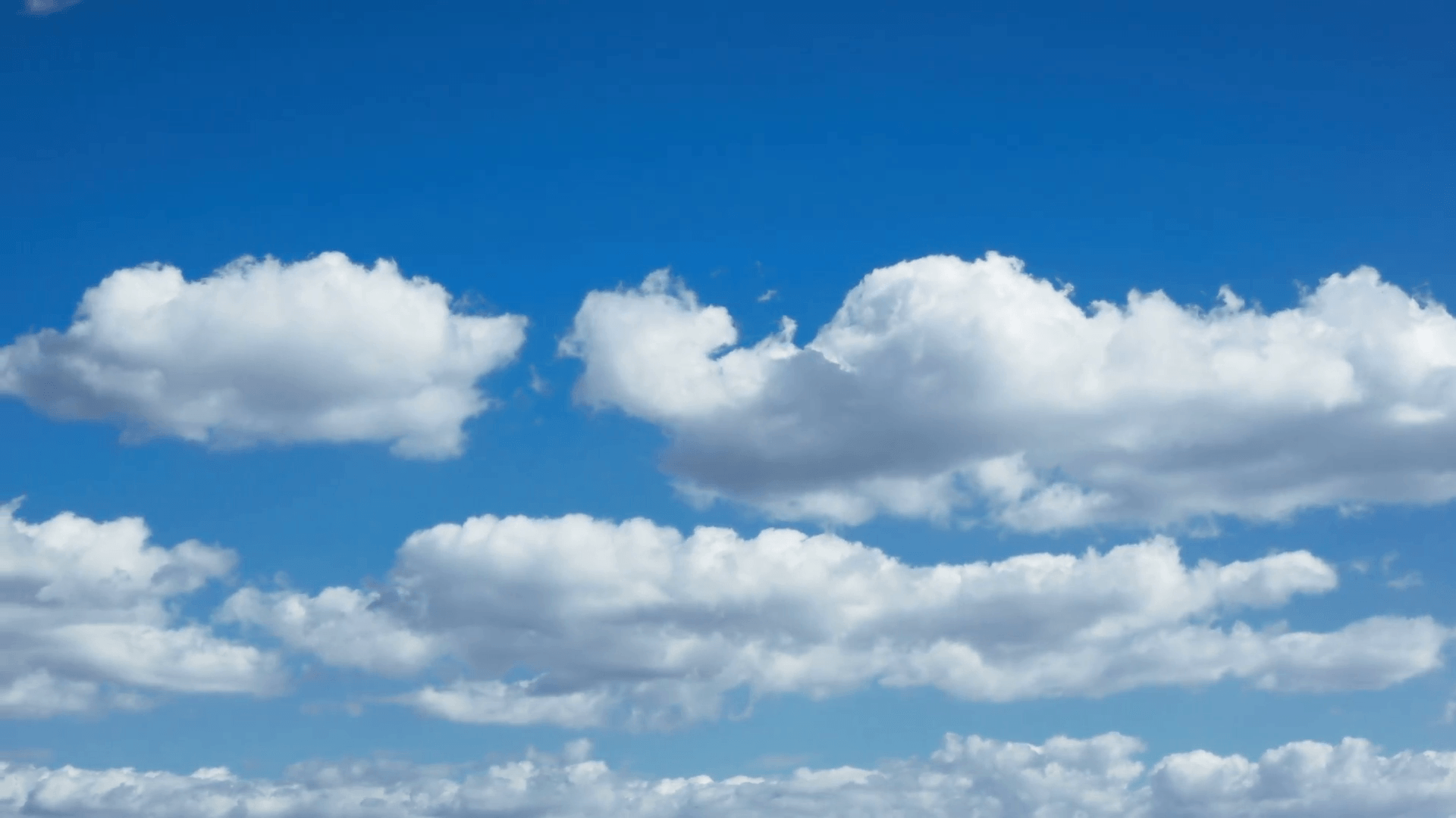 A mediterranean white puffy clouds timelapse on a light blue sky