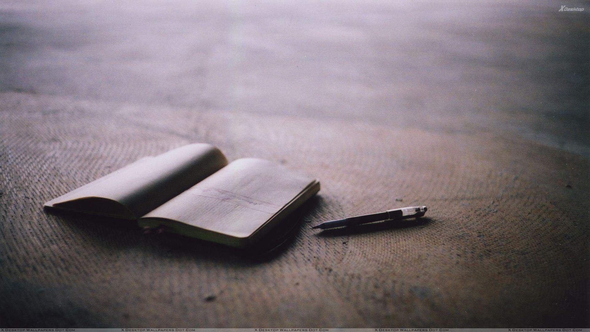 A Book And Pen On Table Wallpaper