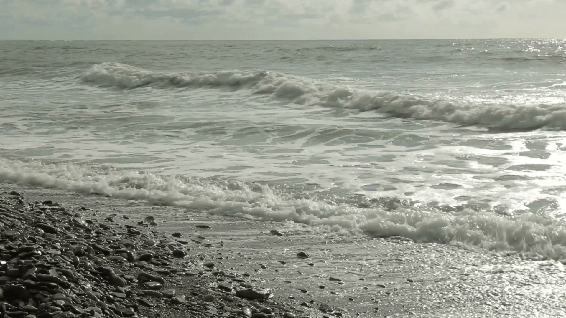 Sea surf at sunshine and storm clouds in the background Stock Video