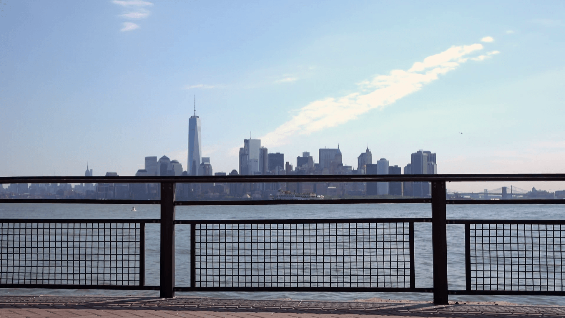 New York City in background with focus on fence along water edge 4k