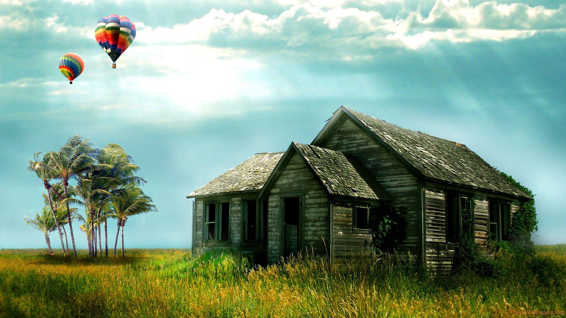 Hot air balloons over an old house wallpaper