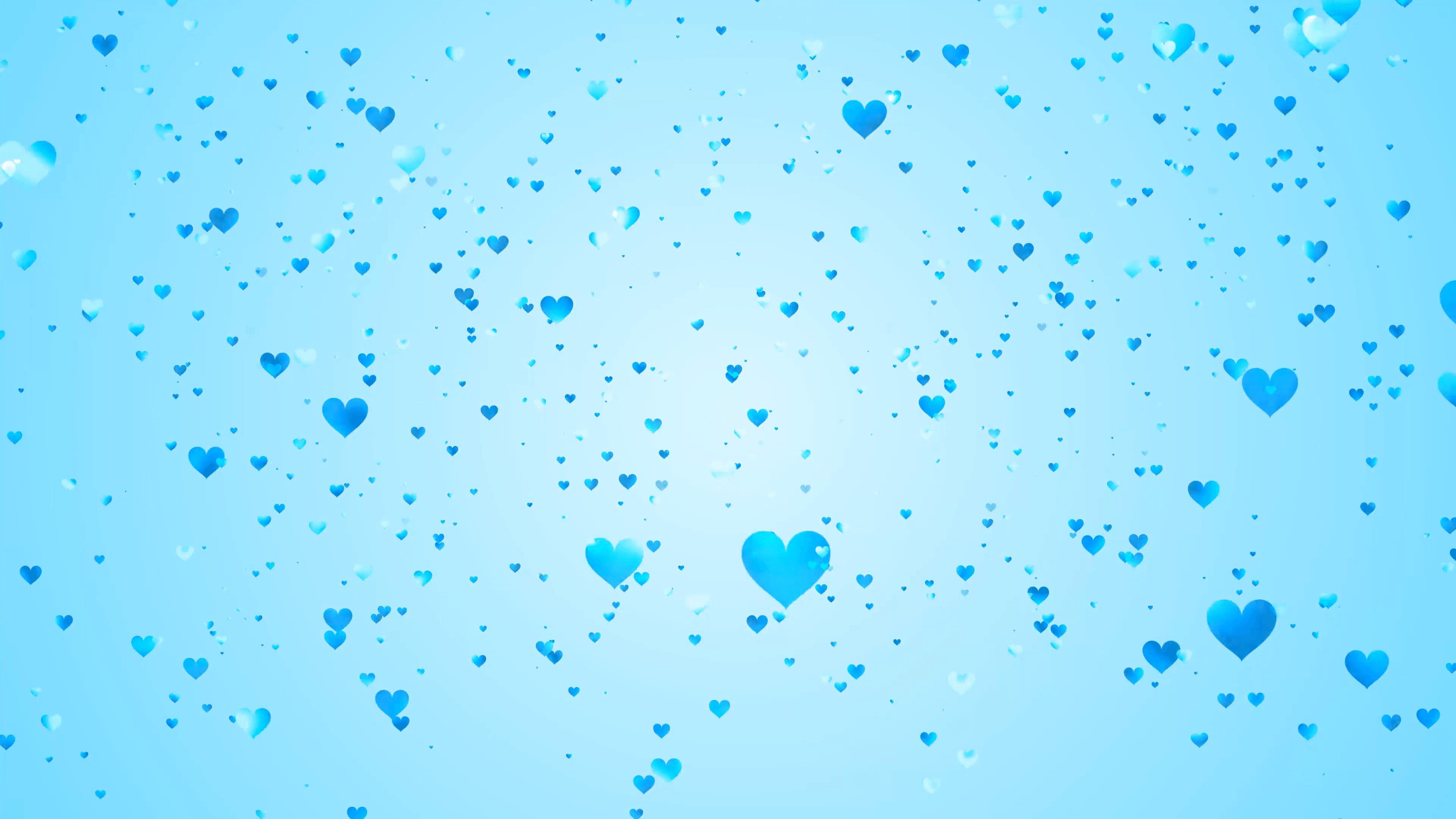 Hundreds of light blue hearts of various shades and sizes slowly