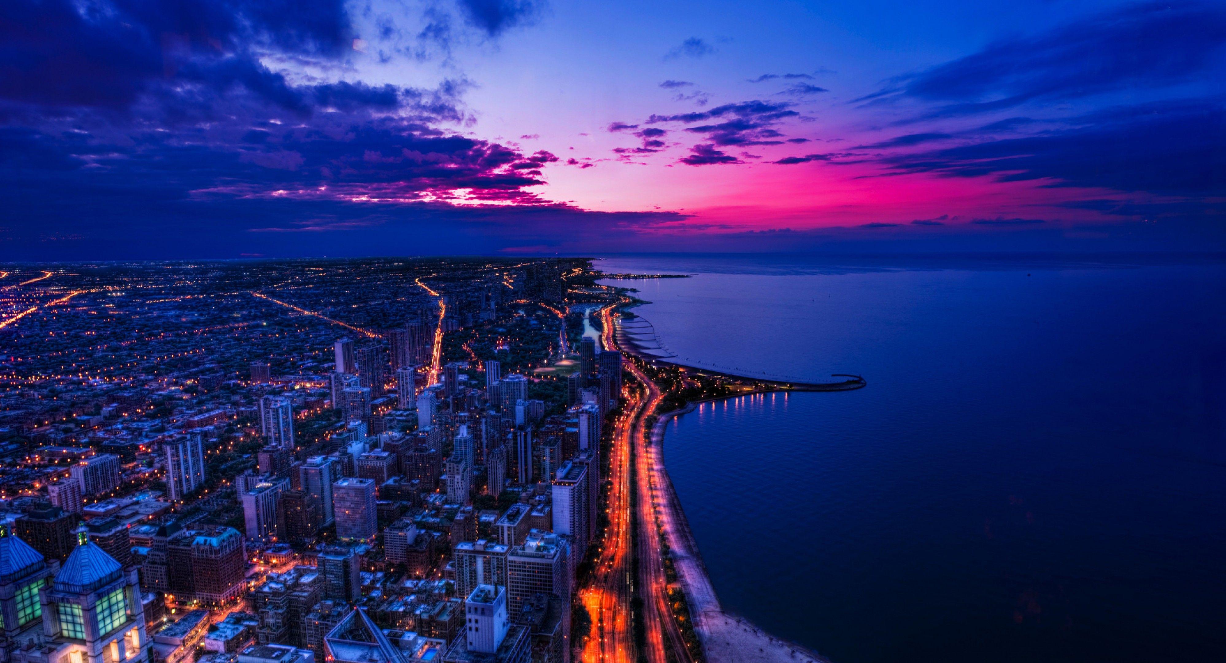 A glowing night time wallpaper of Chicago 4K Flat Cropped