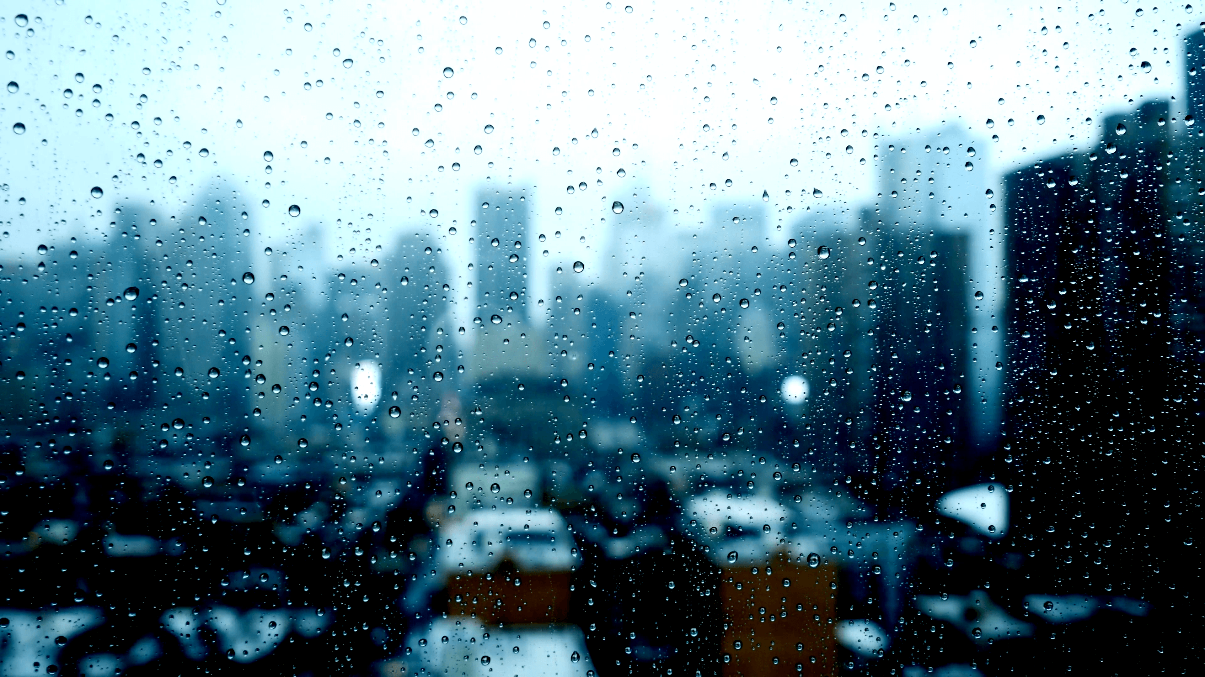 blurry city skyline window view. sad bad weather. rain drops