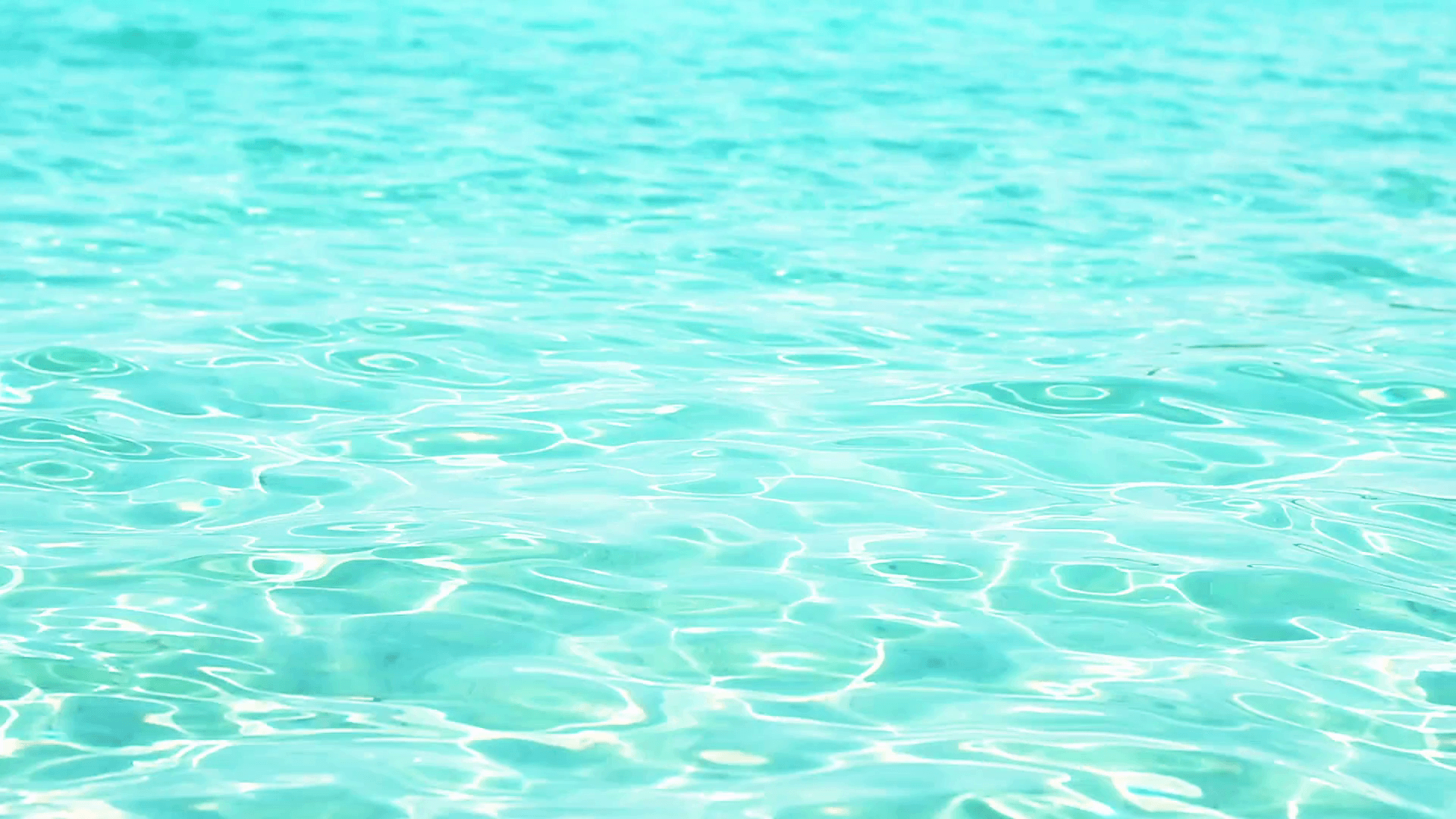 Abstract background of clean turquoise sea with rippled sunlight