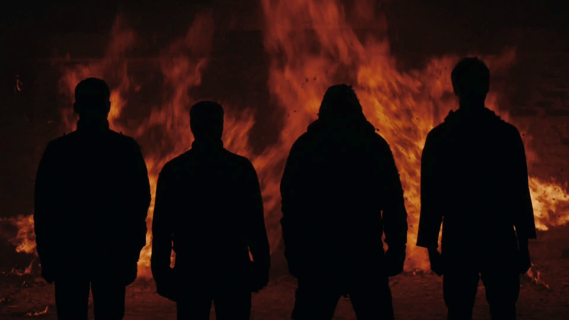 Four man silhouette standing on fire flames background. Silhouette