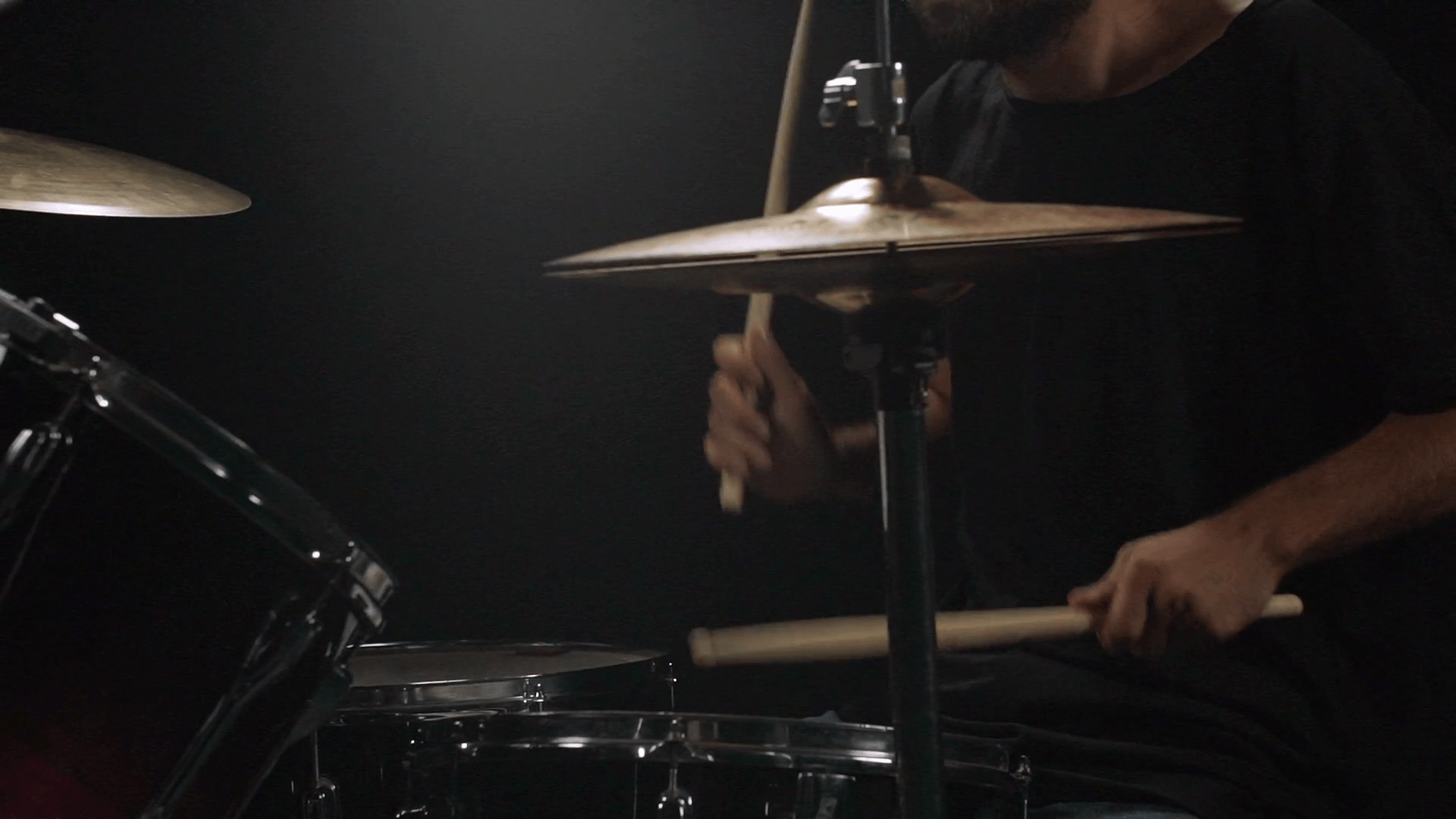 Man playing on drum kit Black background Slow motion Stock Video