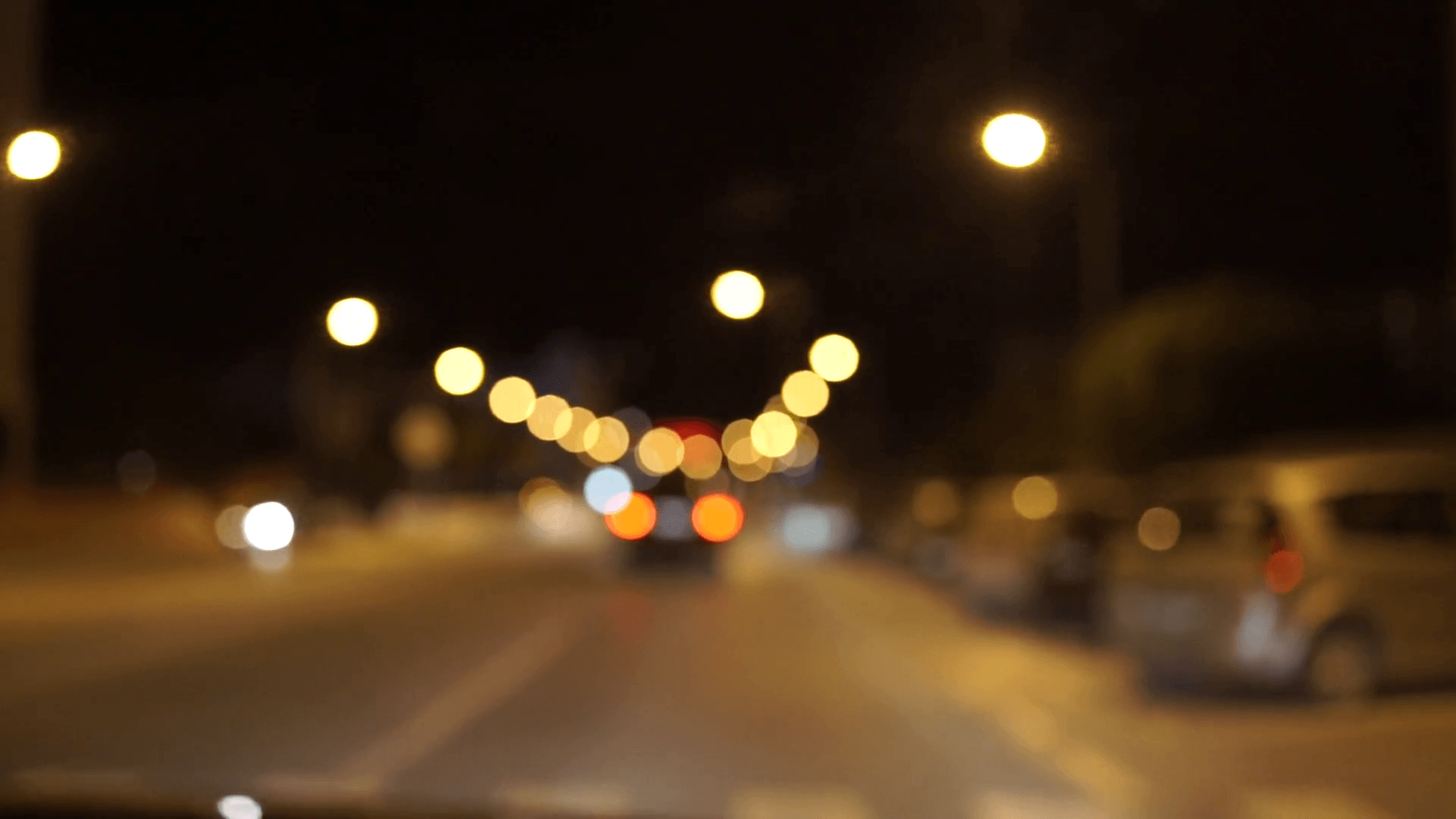 Night city street lights bokeh colorful background. Stock Video