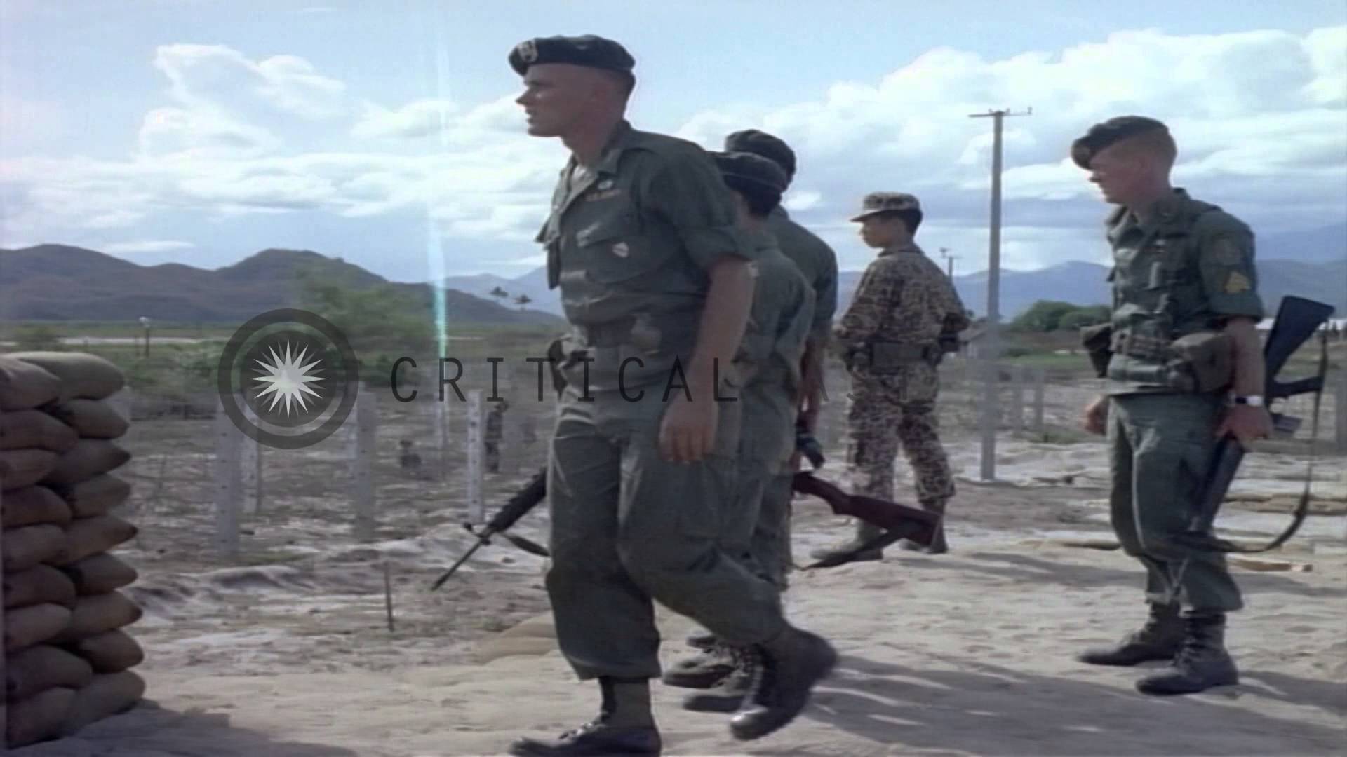 US Army Special Forces officers and Vietnamese officers discuss near