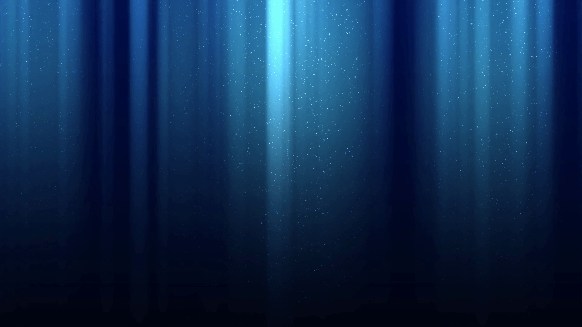 Dark blue abstract background with rays of light and specks