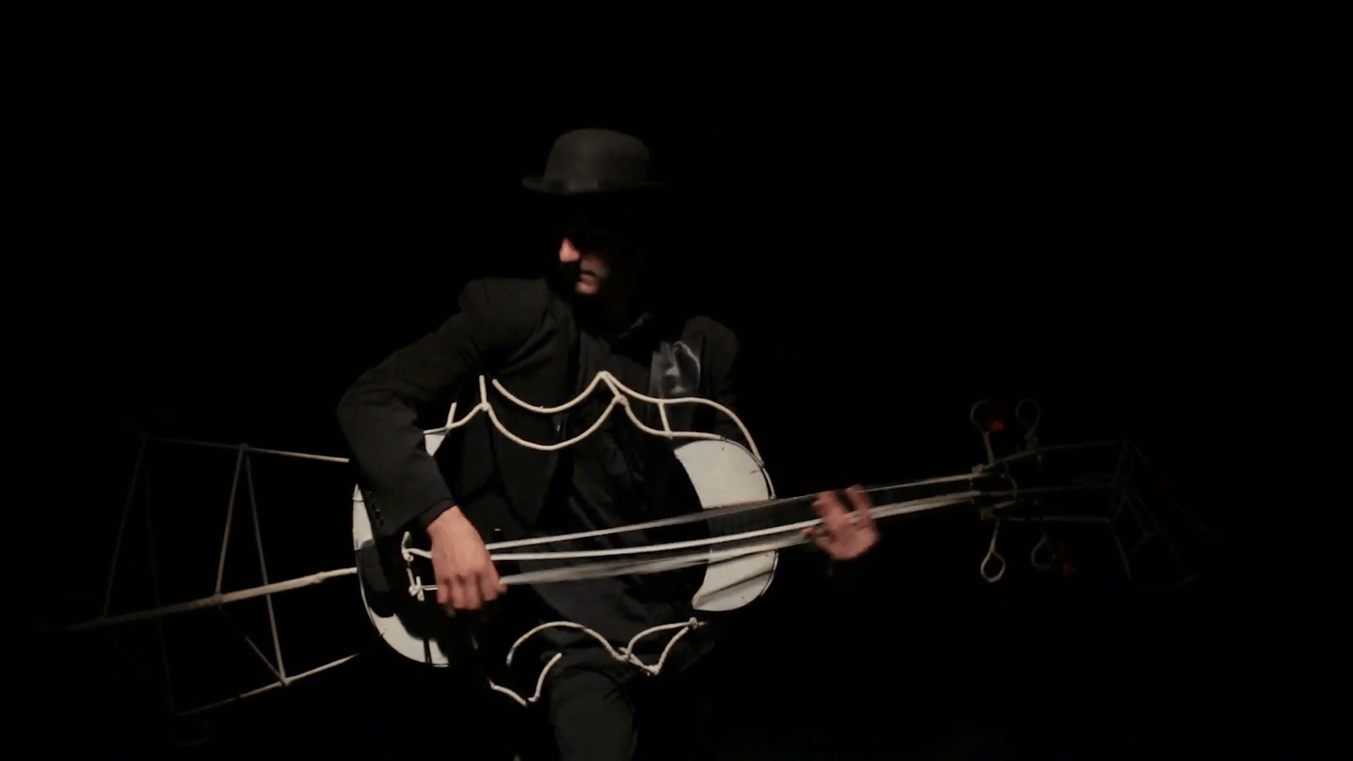 Mime game shows on bass. Black background Stock Video Footage