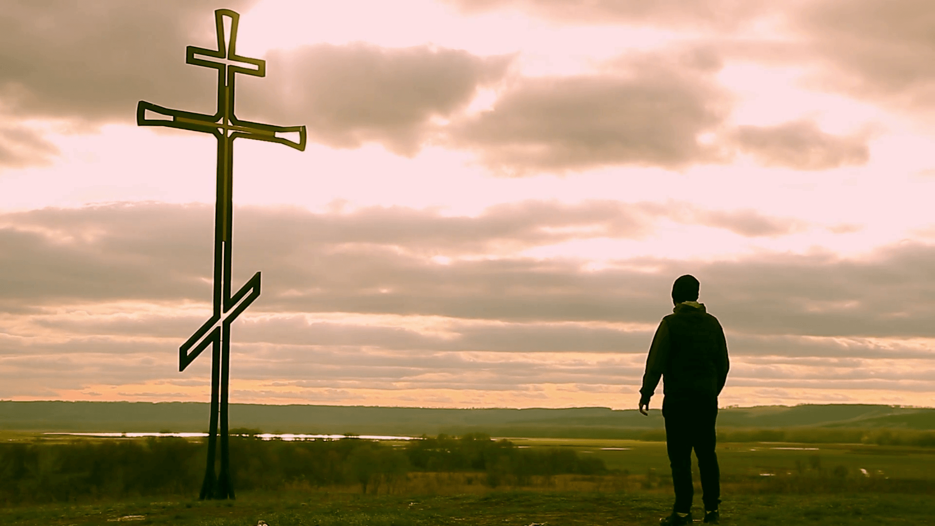 Man holds up a Christian cross crucifix. Stock Video Footage