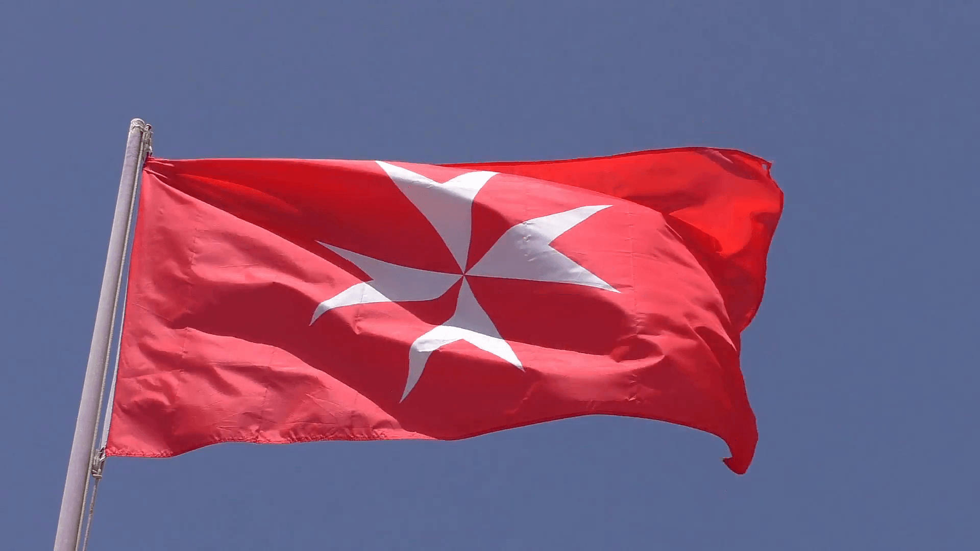 White Maltese cross on red background flag, the national flag