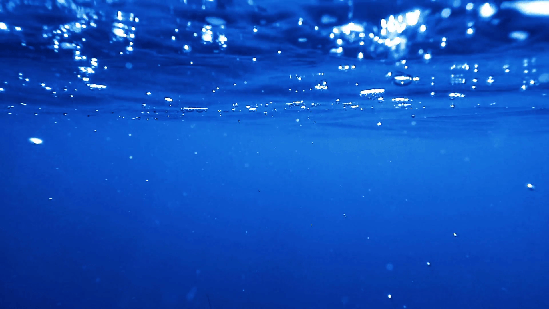 Under the sea, underwater view of blue ocean water with air bubbles