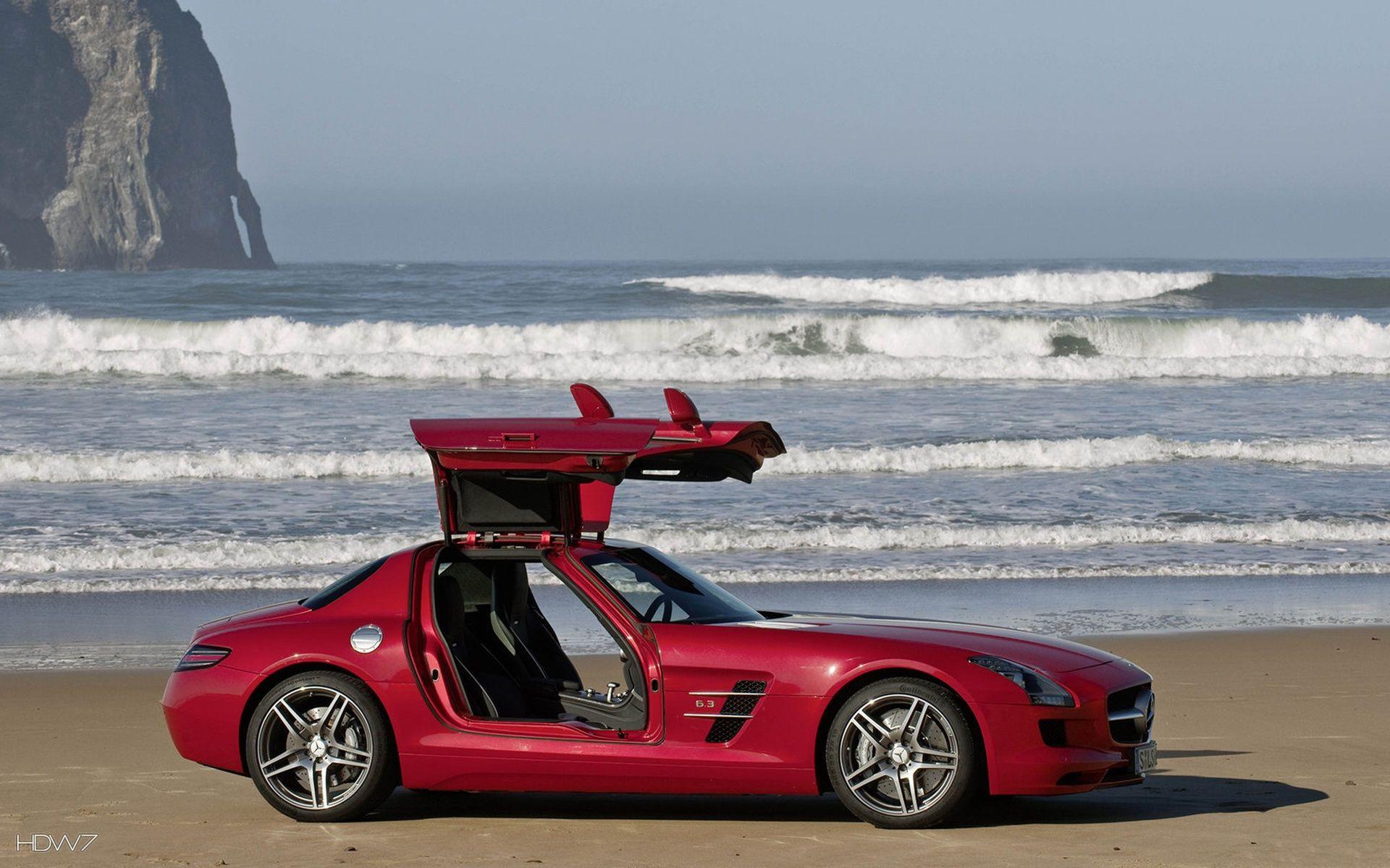 mercedes benz sls amg sports car with doors open at the beach