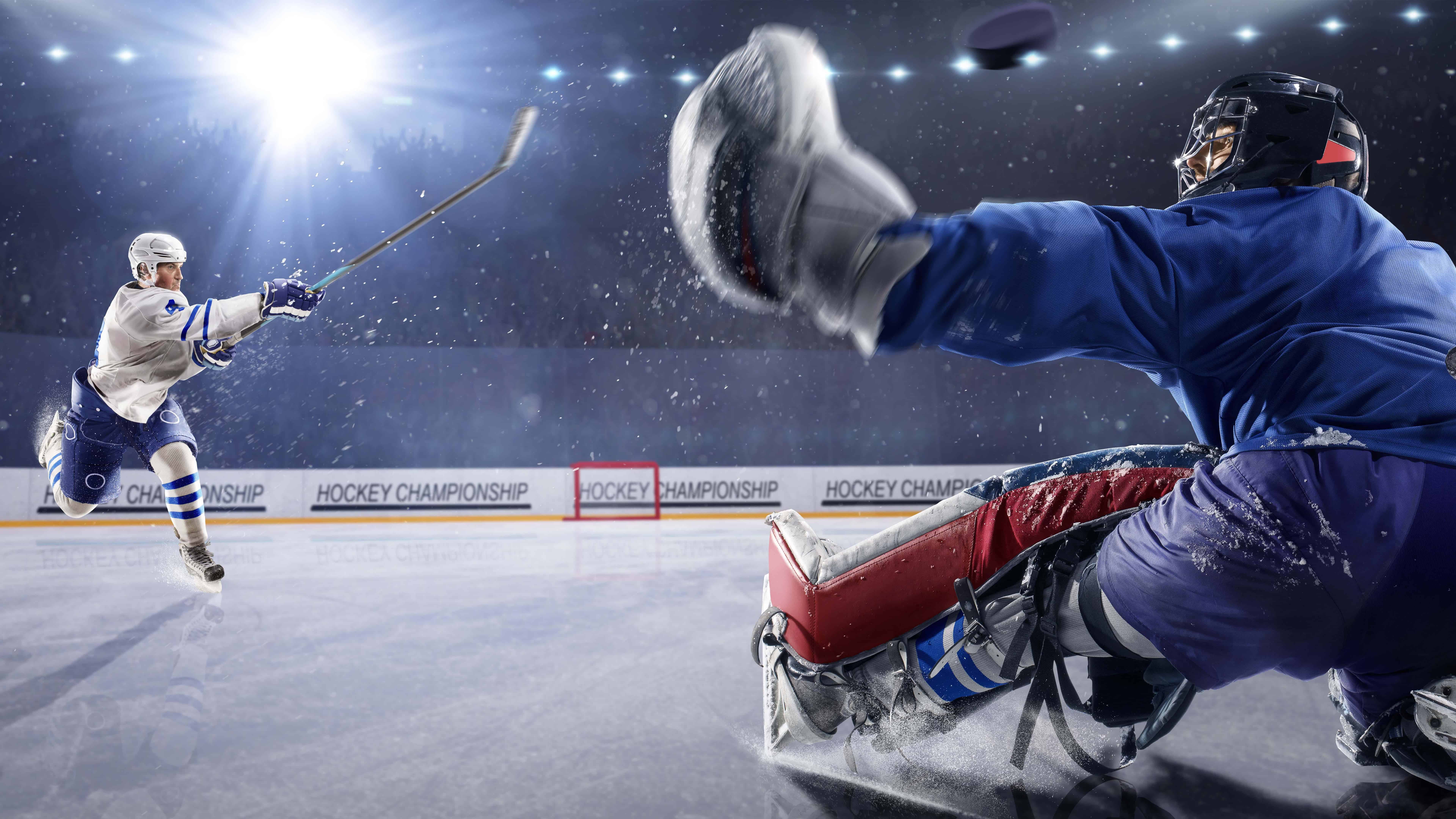 Hockey Player Shooting Puck At Goalie UHD 8K Wallpaper