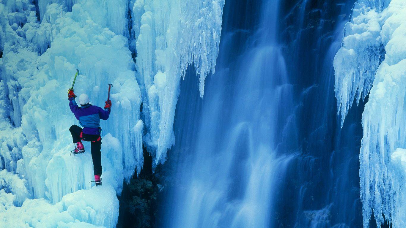 Ice climber ascending a frozen waterfall in Telluride, Colorado