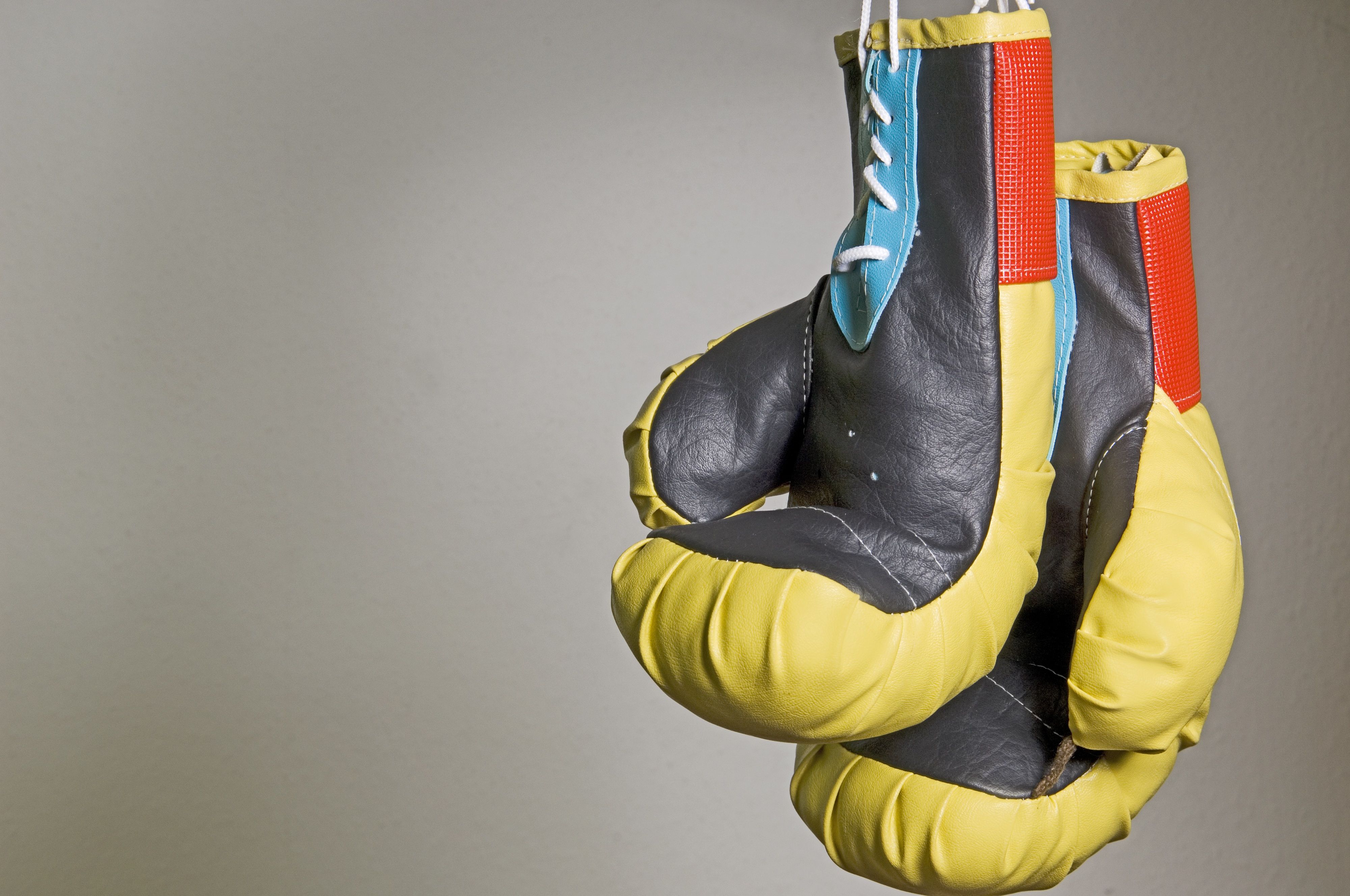 Photo of hanging boxing gloves 4k Ultra HD Wallpaper. Background