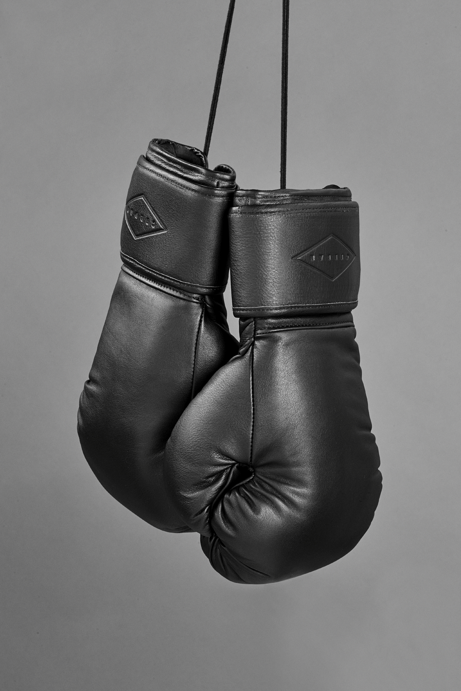 hanging boxing gloves black background