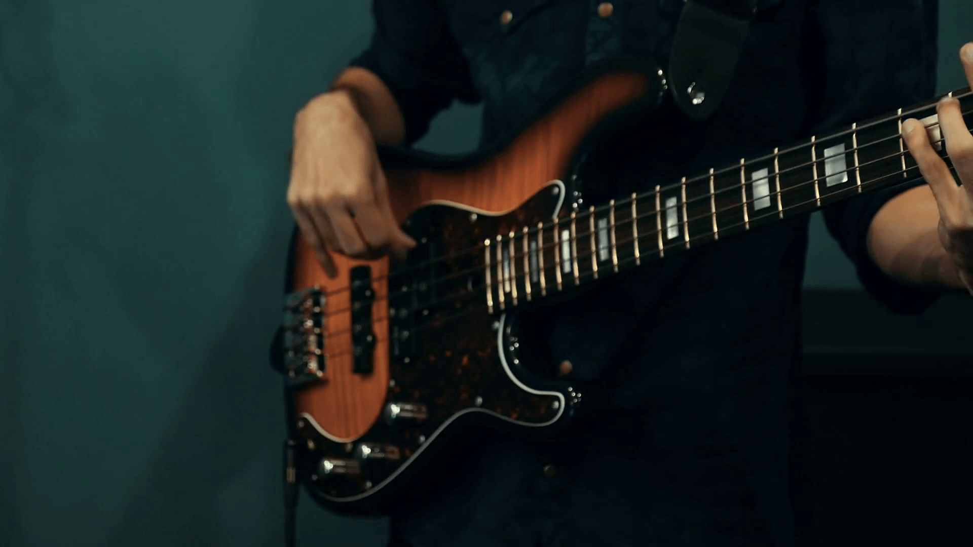 Bass Electric. White and brown guitar. Musician plays rock music