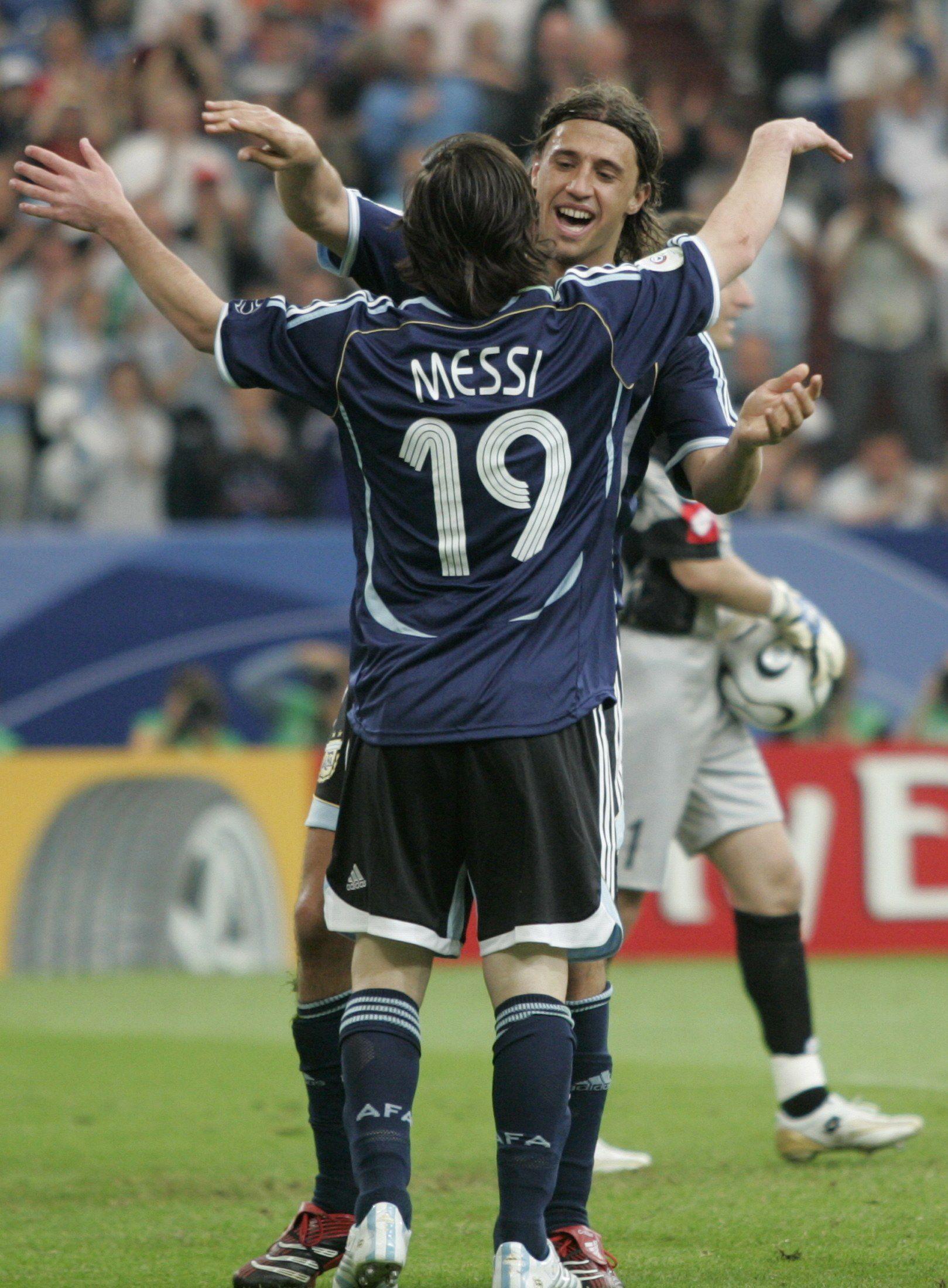 Argentina's Messi embraces his teammate Hernán Crespo after his goal