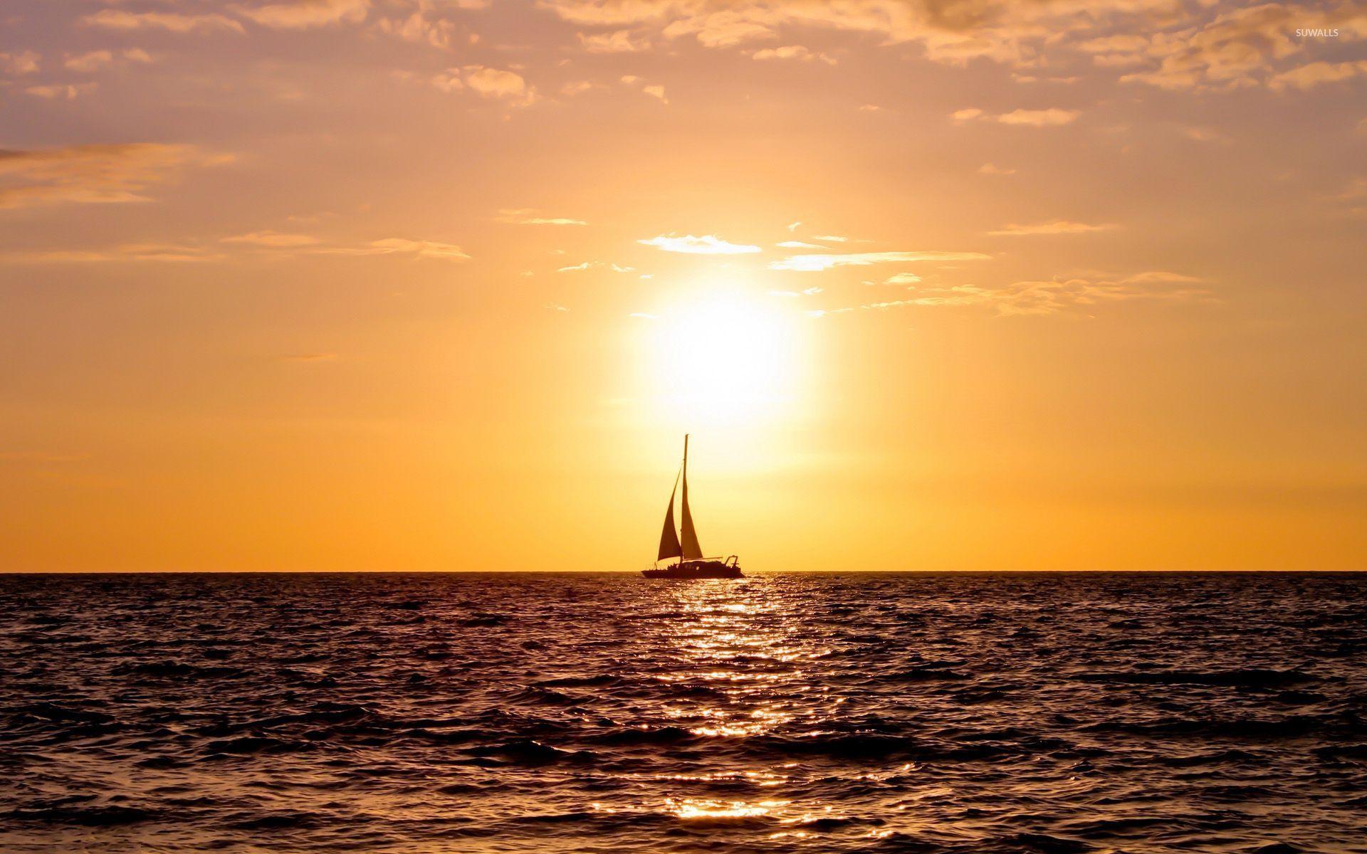 Sailing ship enjoying the ocean sunset wallpaper