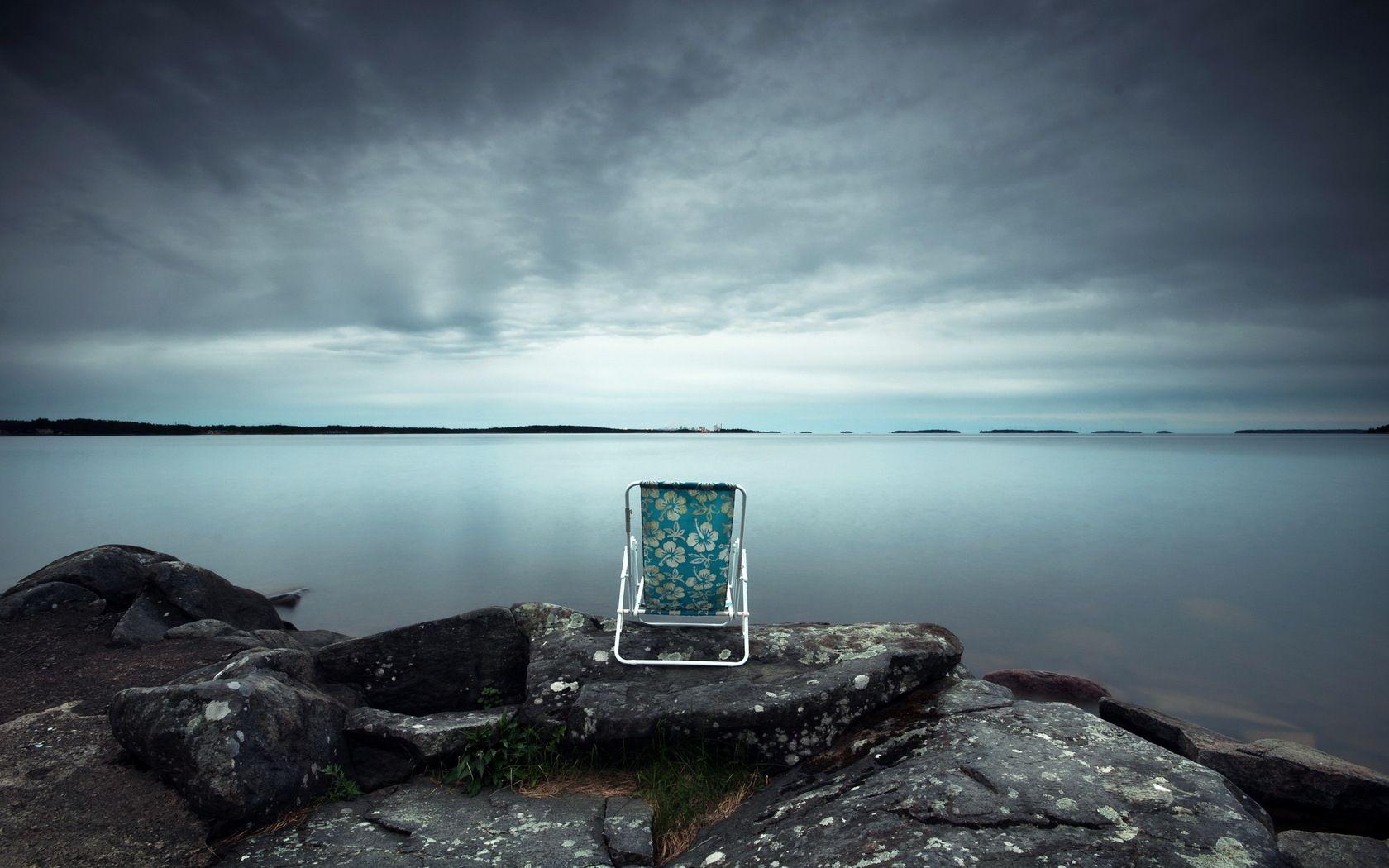 Alone Chair On Sea Stone Wallpaper