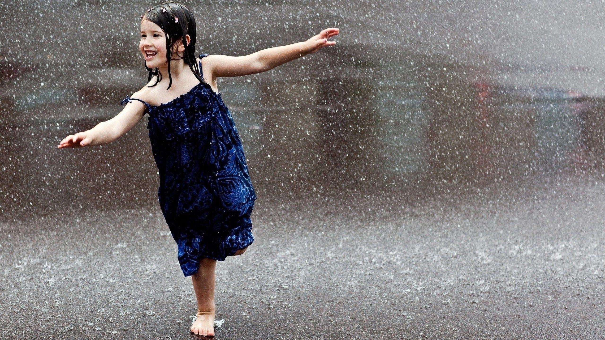 Happy child runs in the rain wallpapers and image.