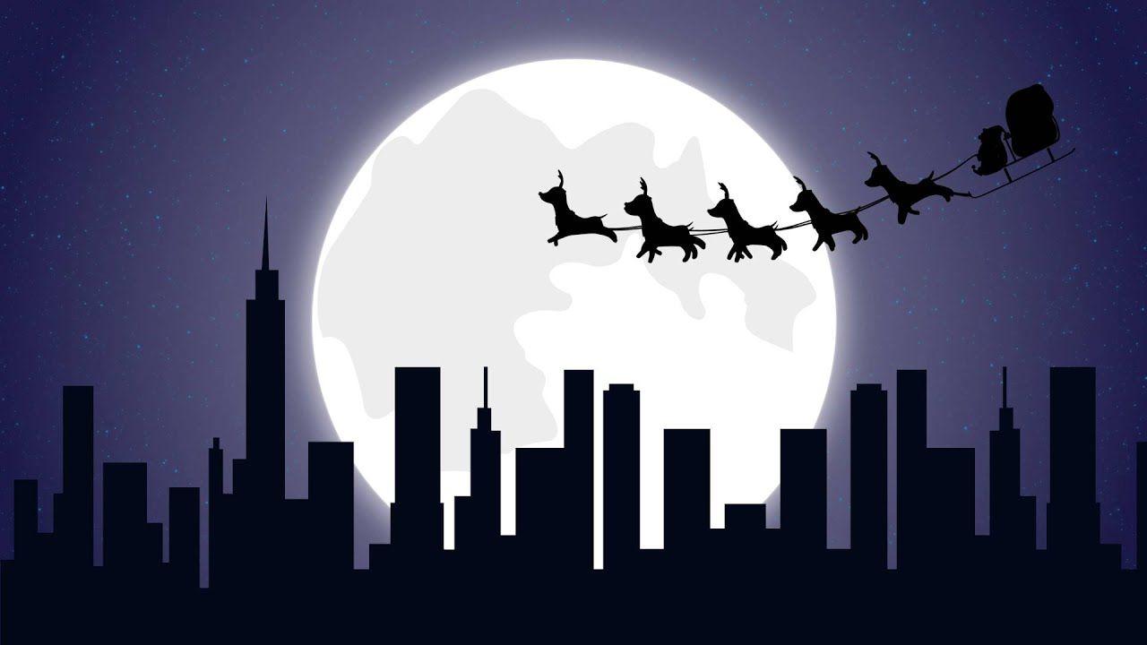 Christmas flying Santa sleigh reindeer's at night over skyscraper