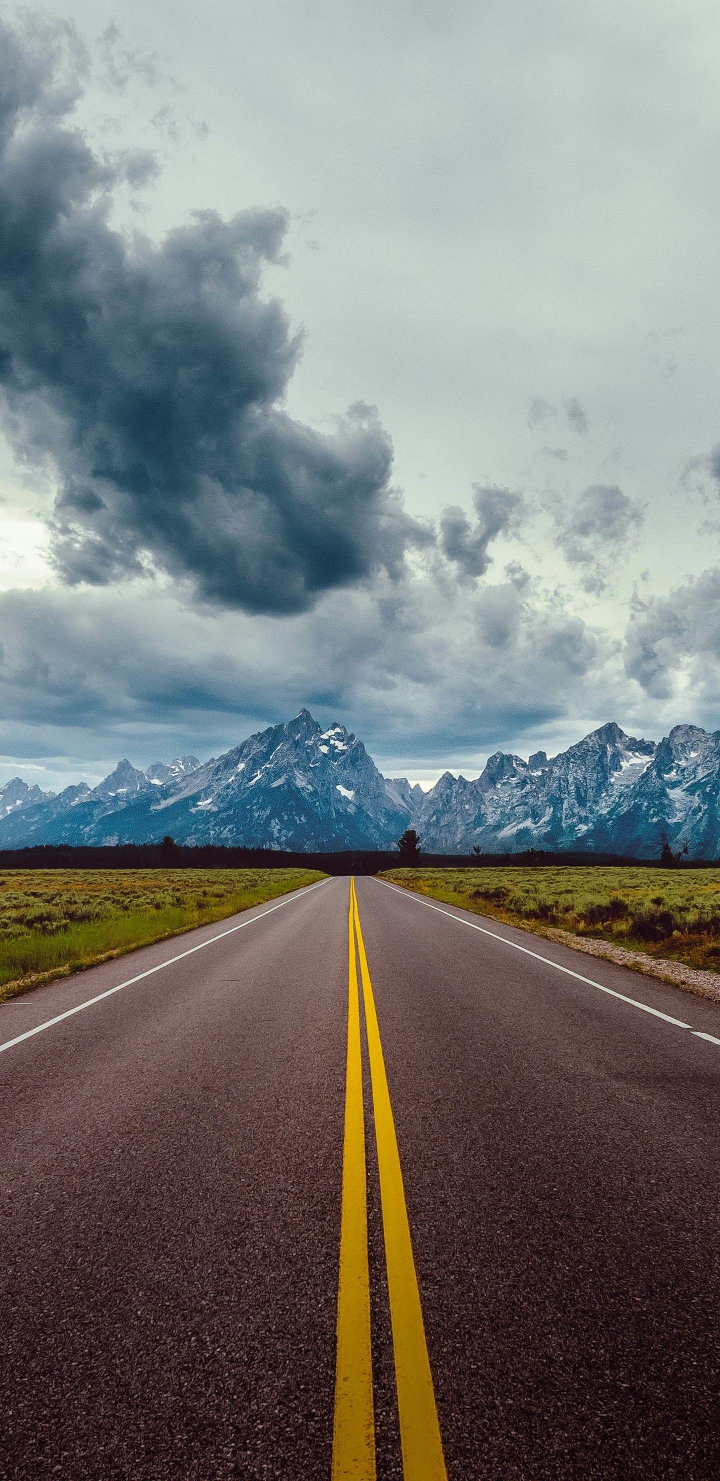 Download 1440x2960 Long Road, Mountains, Dark Clouds, Scenic
