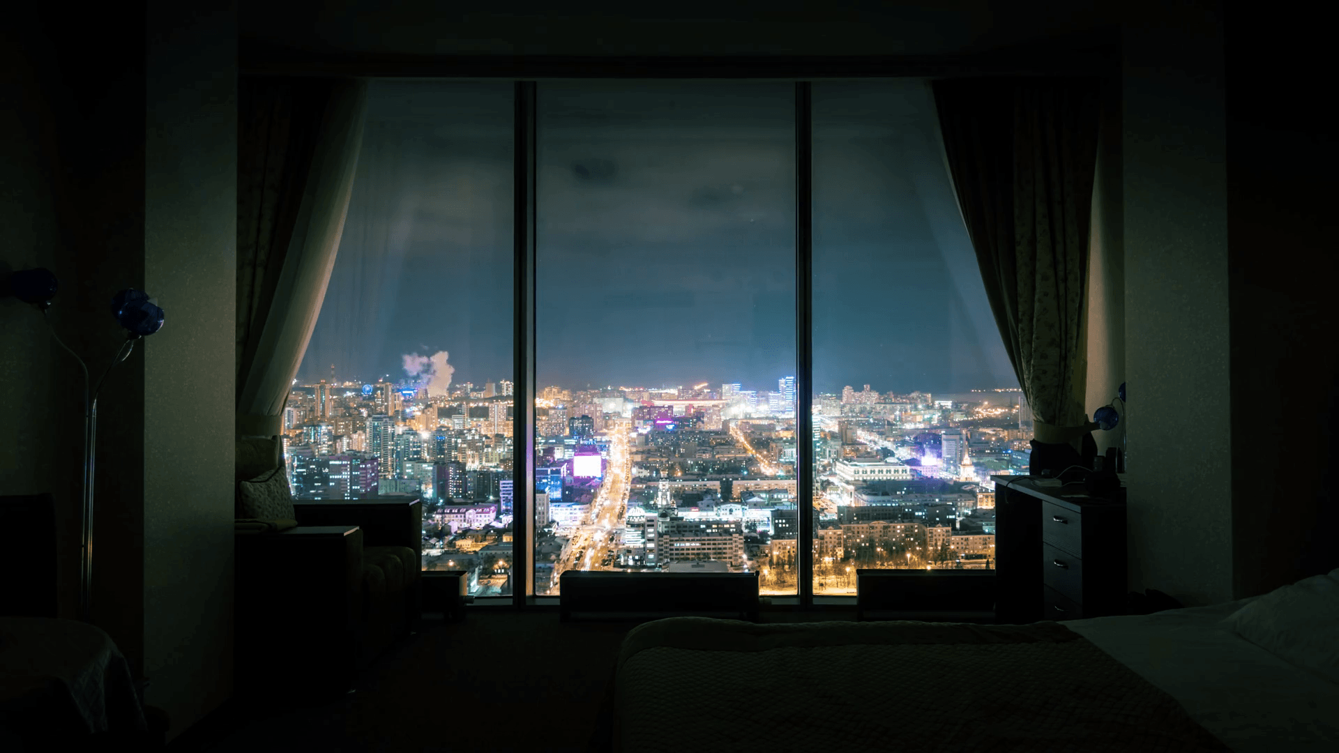 Night city skyline, view from dark room with panoramic window