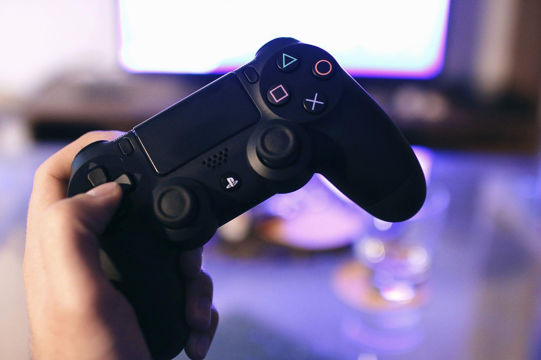 wallpaper. person holding sony ps4 game controller