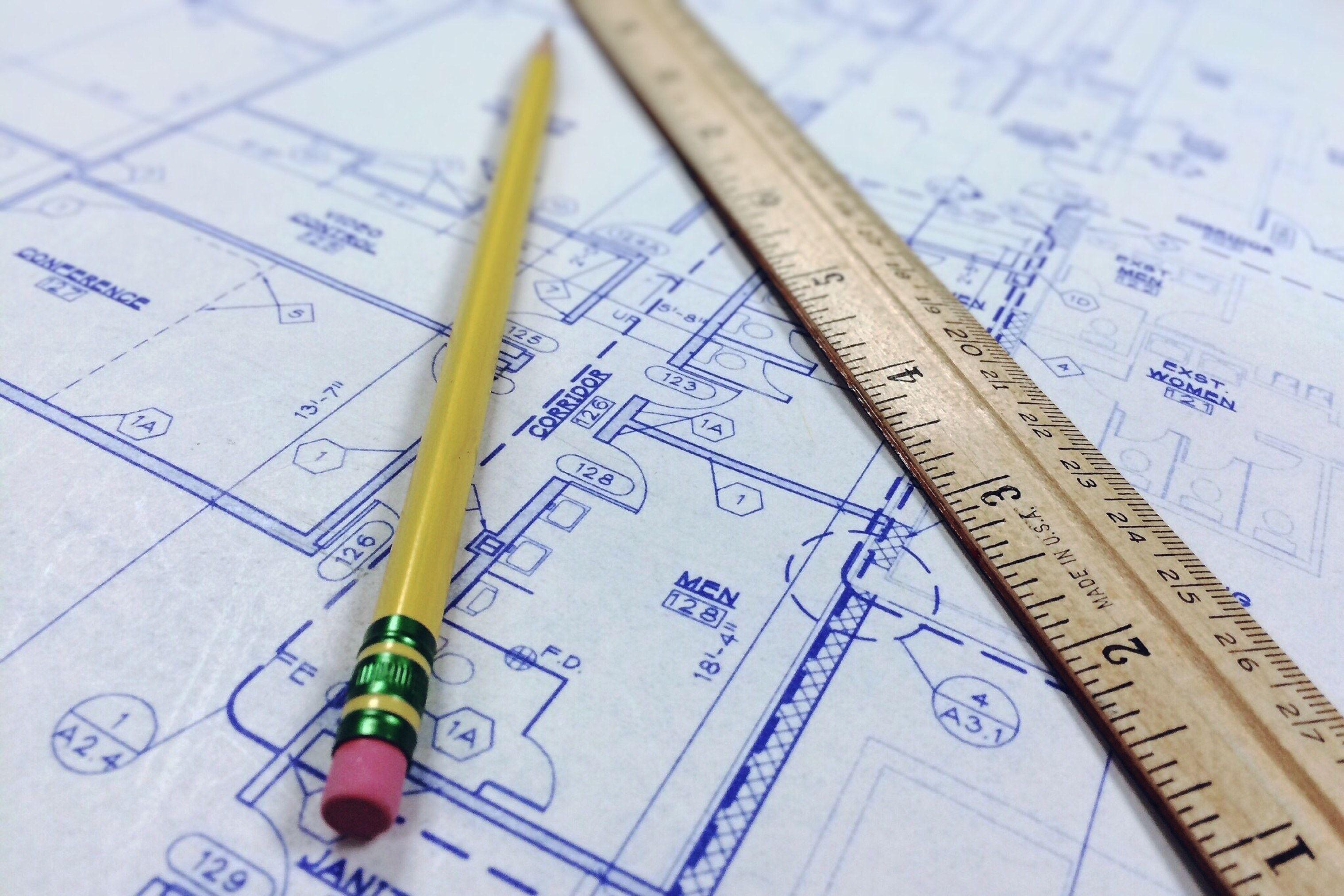 brown ruler and pencil at the top of floor plan paper free image