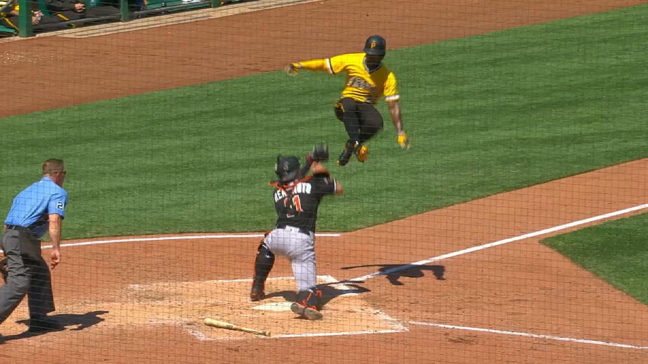 Andrew McCutchen tries hurdling catcher J.T. Realmuto at home plate