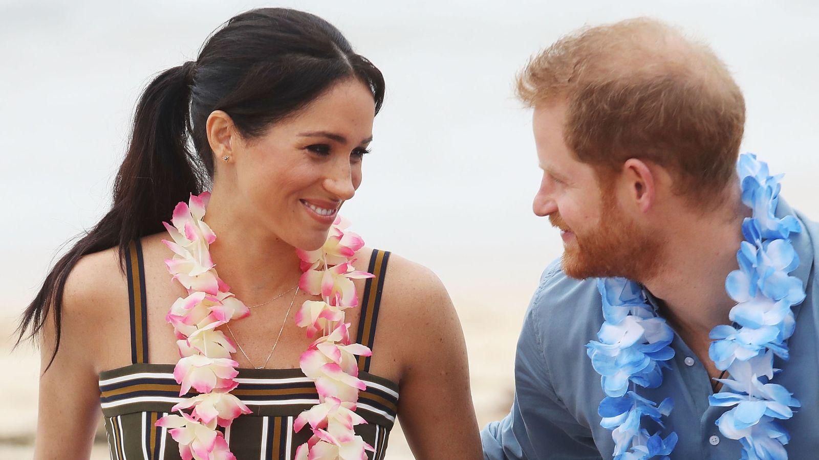 Barefoot on the beach! Harry and Meghan hit Bondi