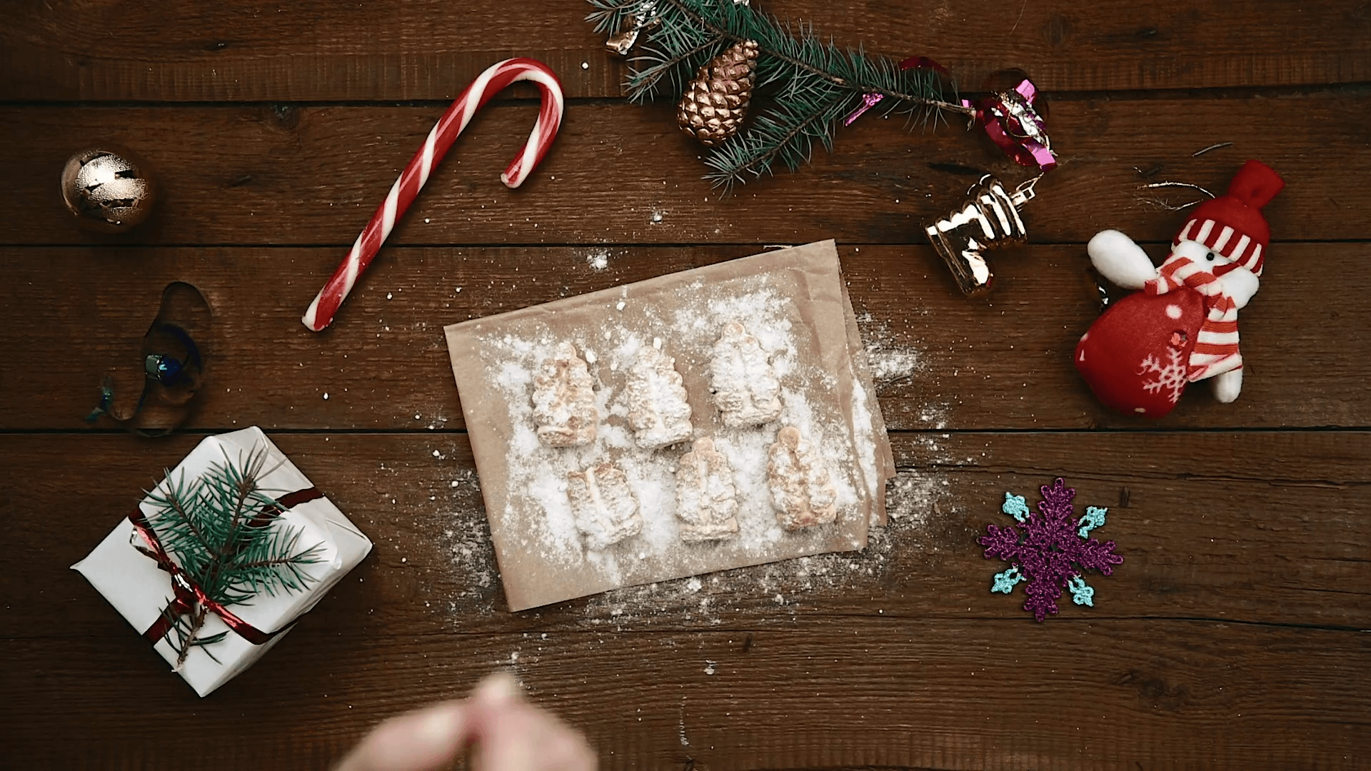 Top view of family taking and eating Christmas cookies at decorated