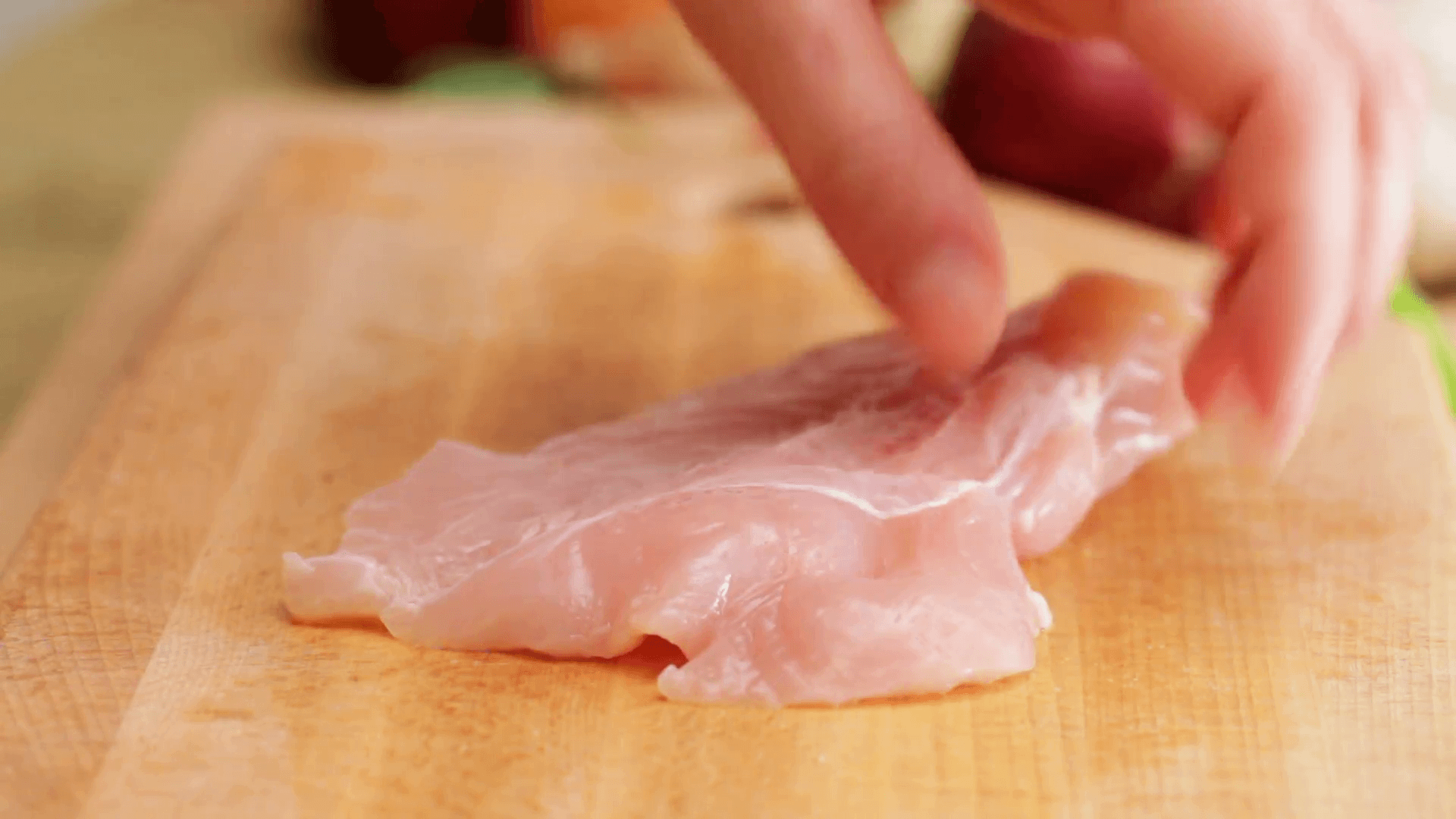 Chef chopping chicken brests onto cubic chunks, closeup Stock Video