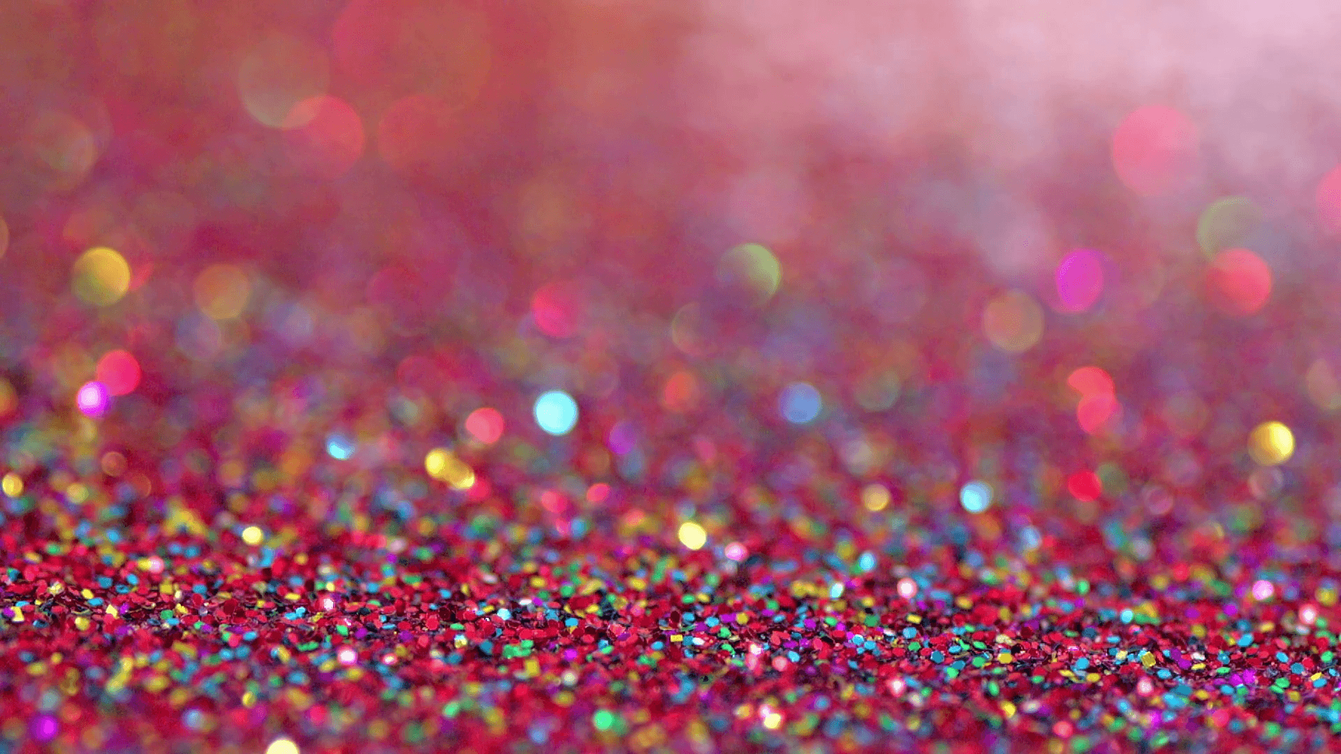 Colourful blue glitter falling on red glitter. Perfect party glitz