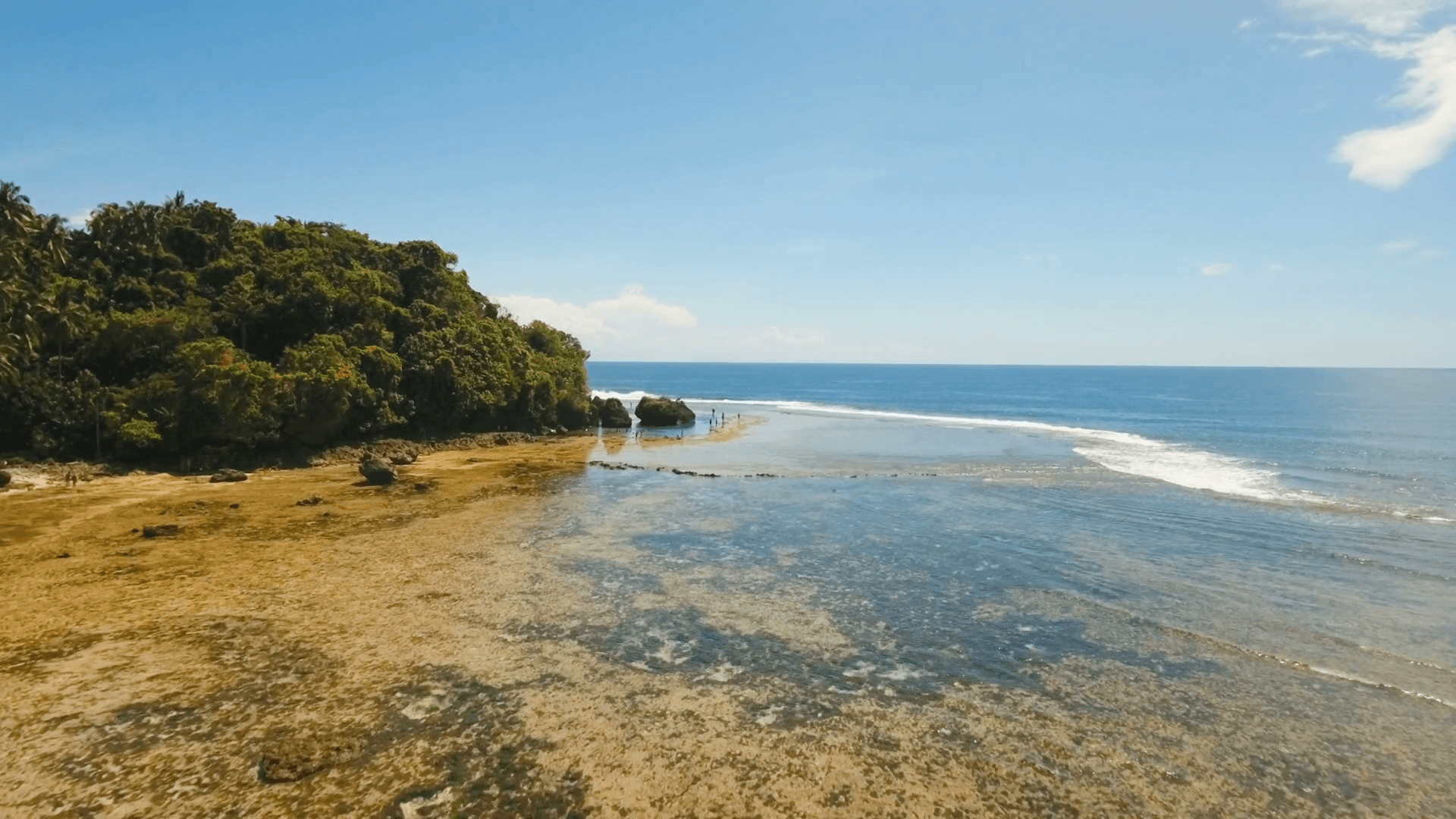 Tropical beach with natural rock pools in the Siargao Island. Aerial