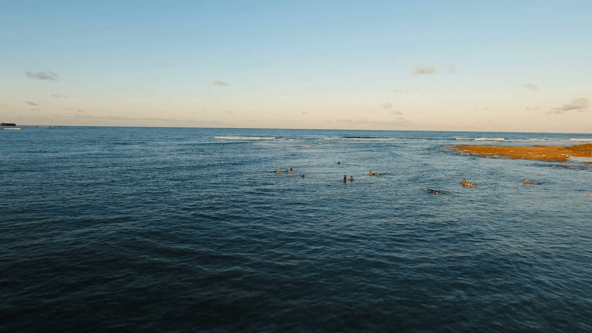 Surfers at sunset in siargao islands famous surf break cloud 9 near